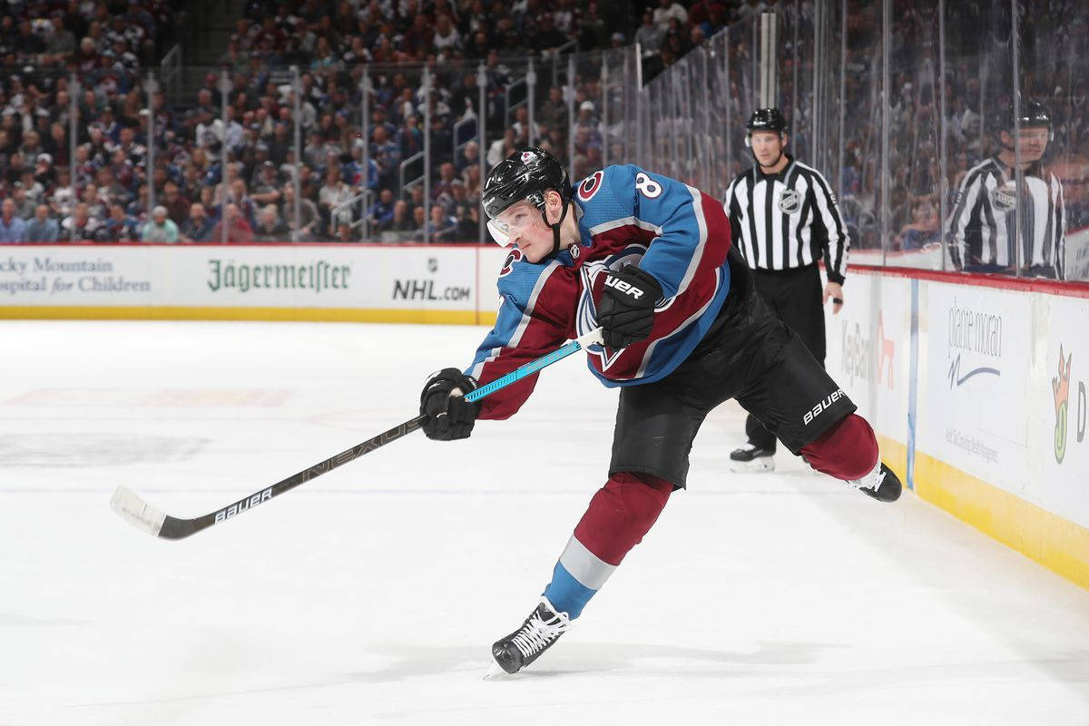 Cale Makar Deftly Passes The Puck In A Tense Game Moment. Background