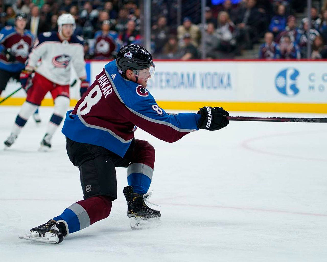 Cale Makar In Action During A Hockey Match Background