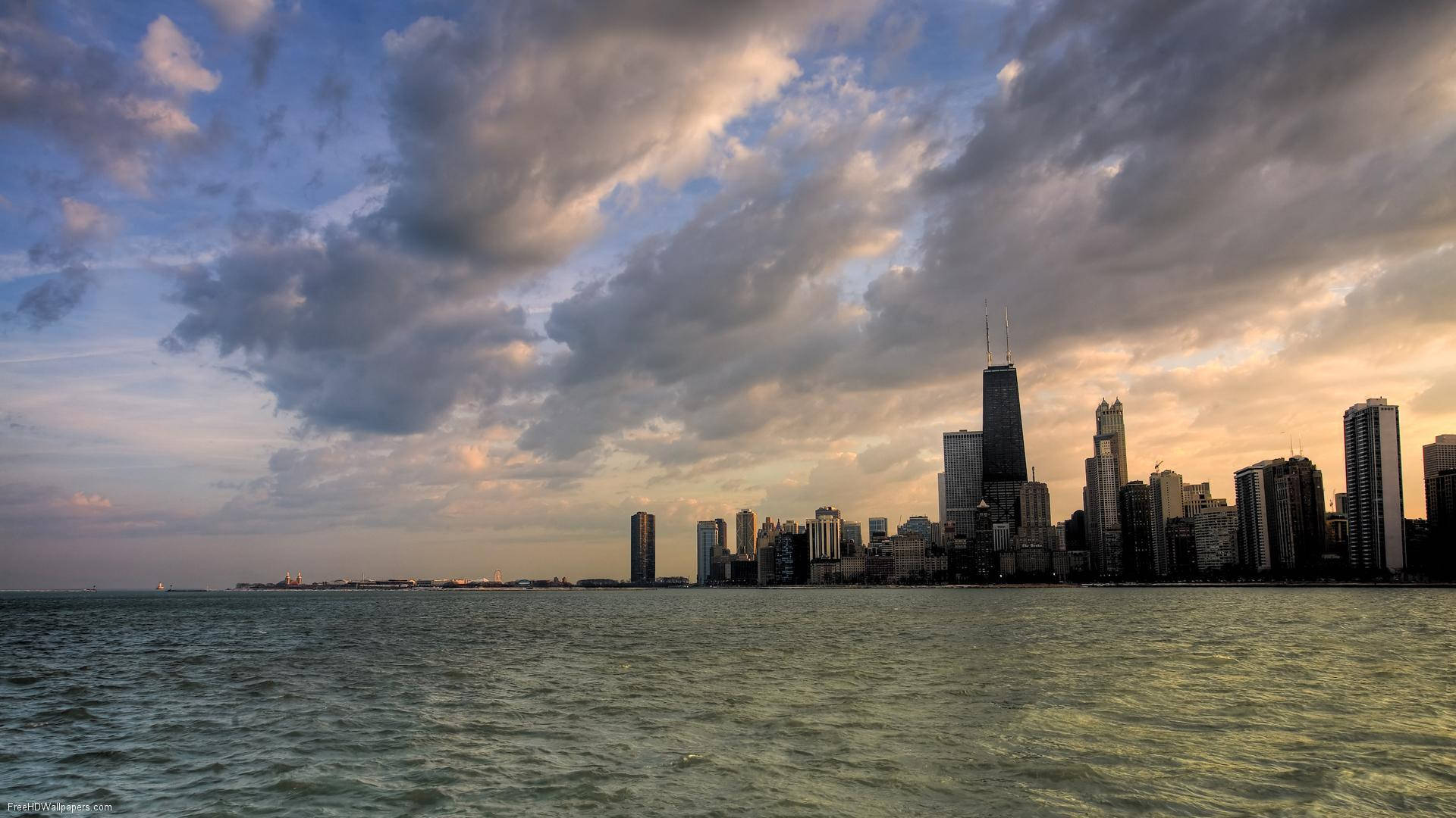 Calm Ocean Under Cloudy Chicago Skyline Background