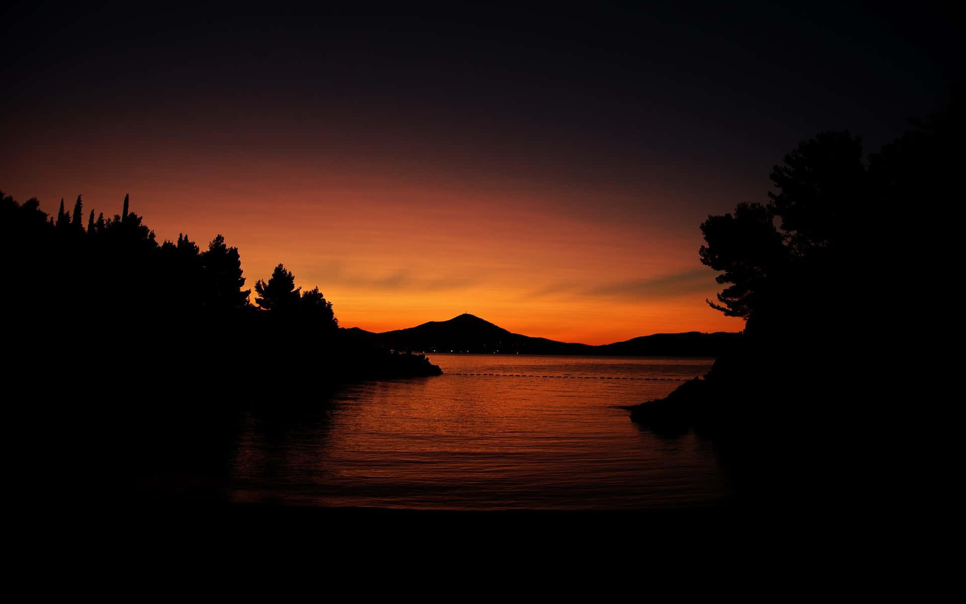 Calm Waters With Trees And Mountains During Evening