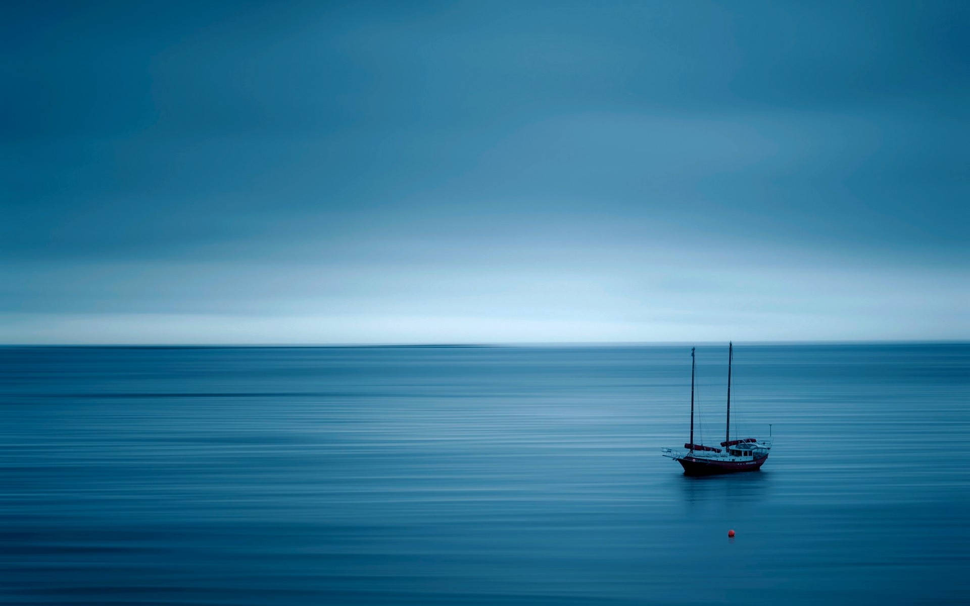 Calming Boat At Blue Sea Background