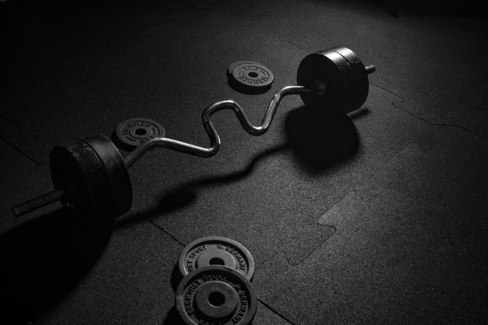 Cambered Barbell And Plates Background