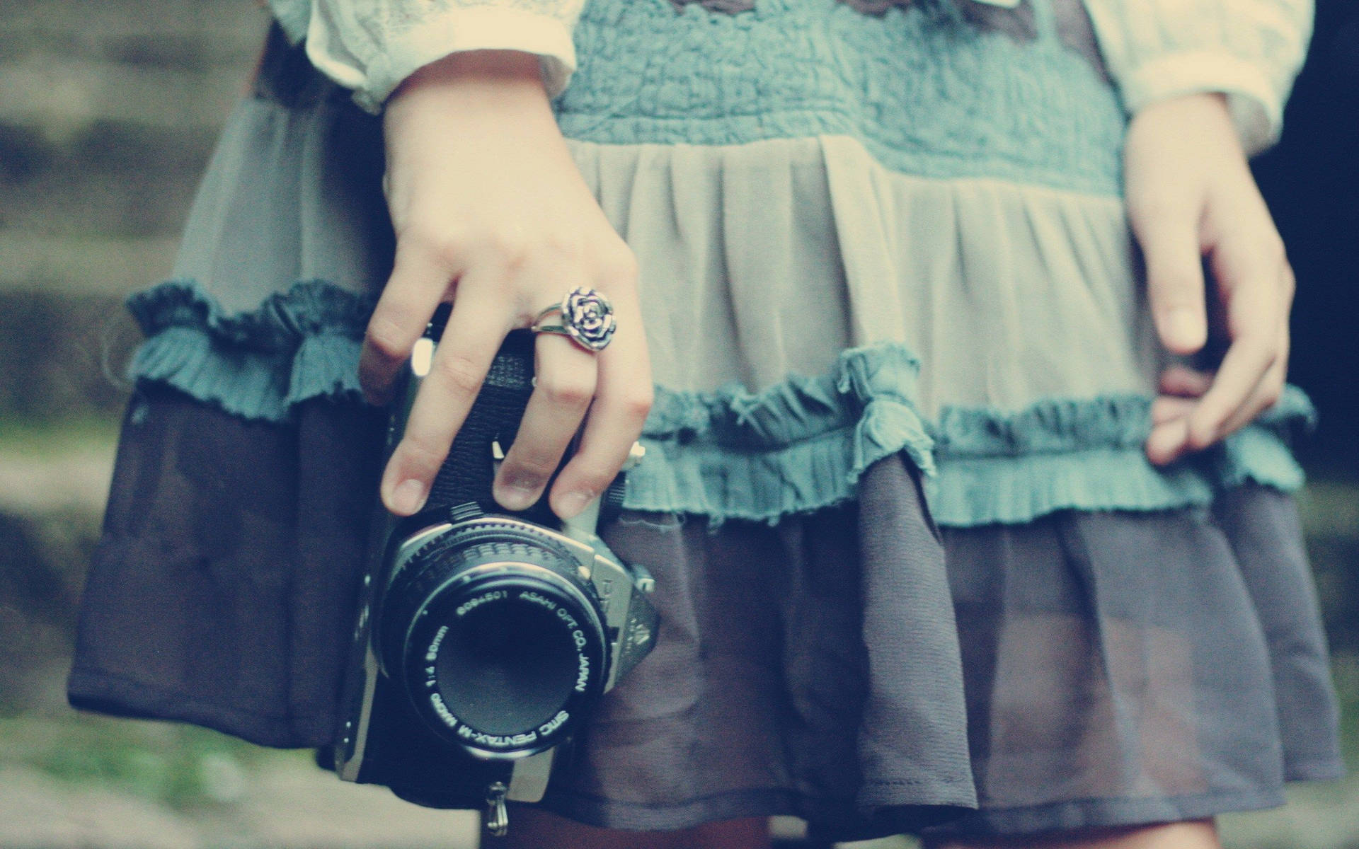 Camera Held By Woman Background