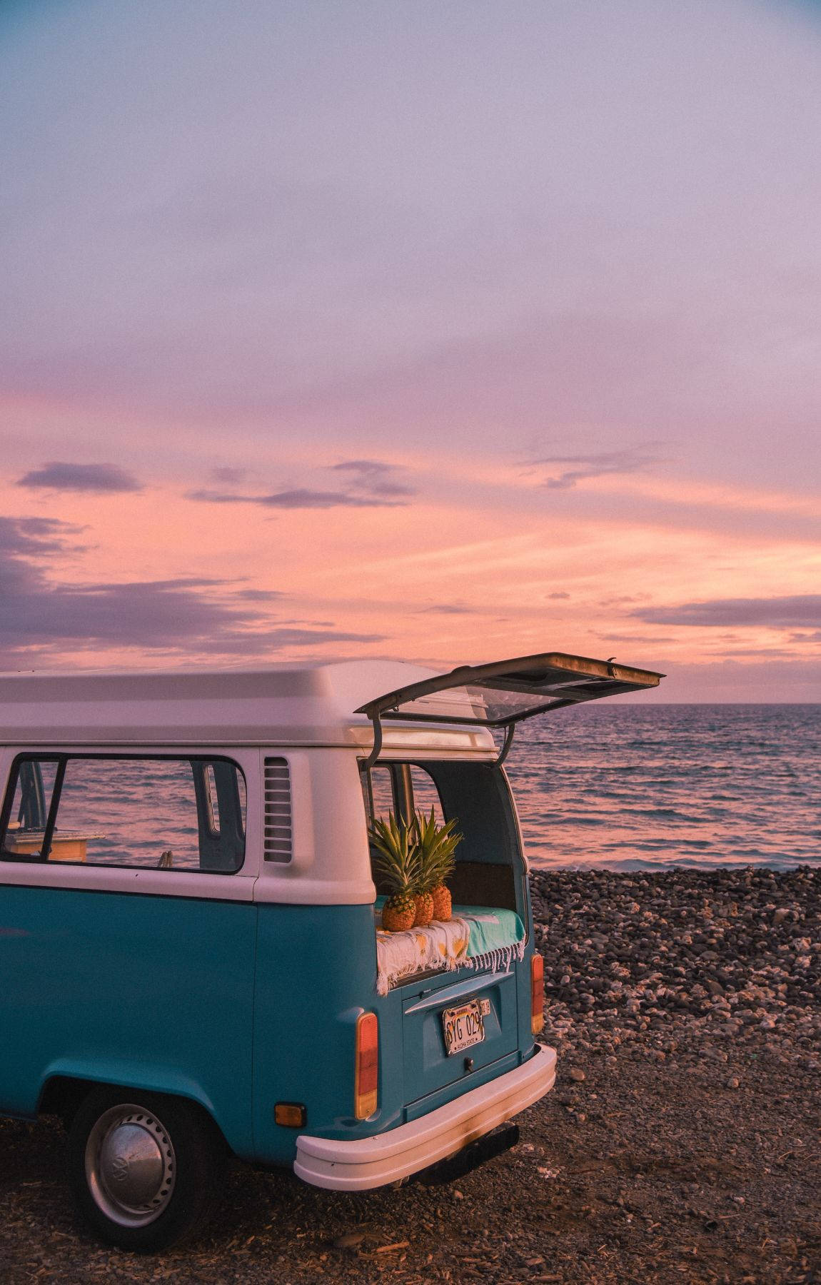 Camping Van With Pineapple On Purple Beach Sunrise Background