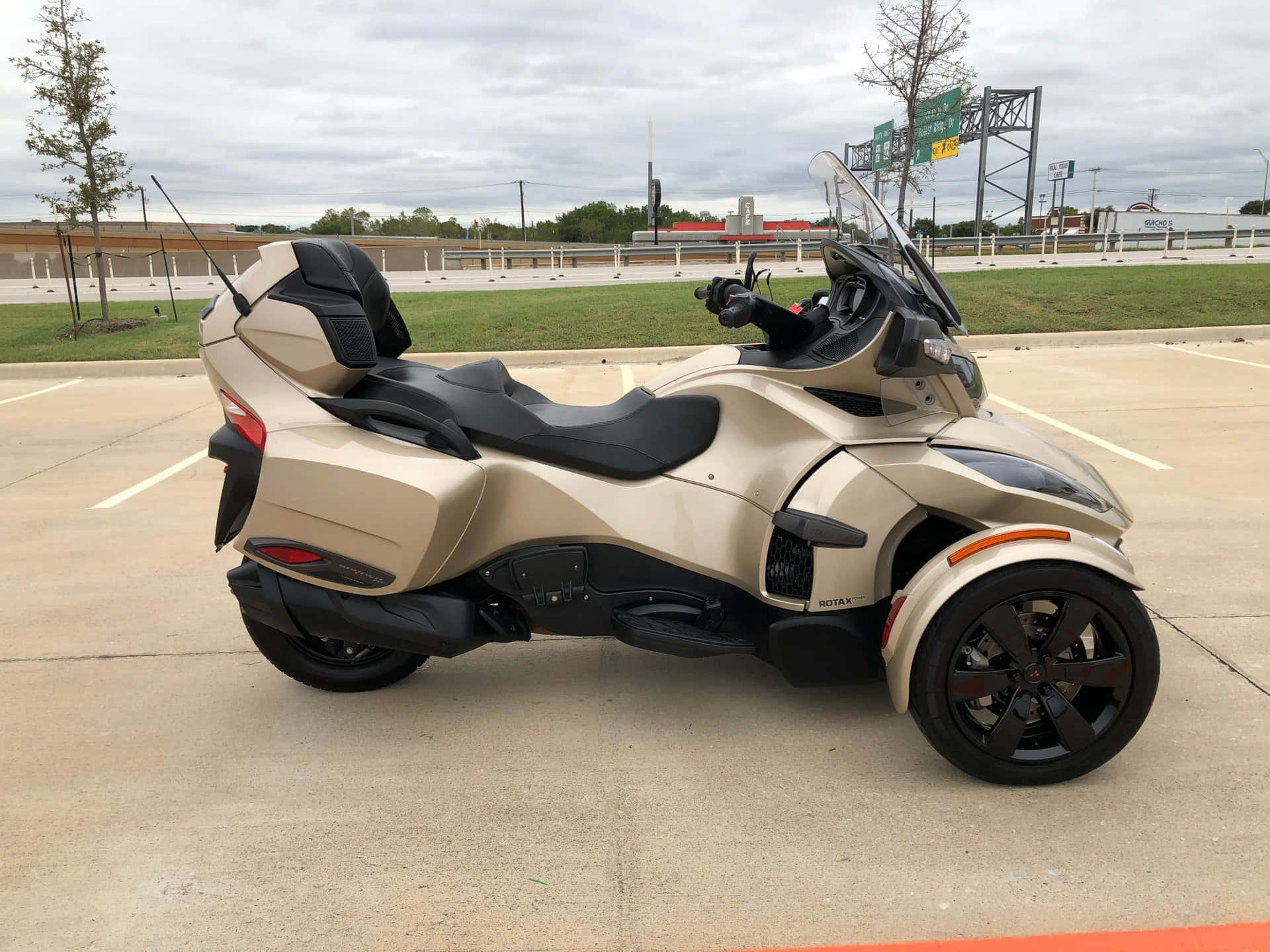 Can Am Spyder Three Wheeled Motorcycle Parked Background