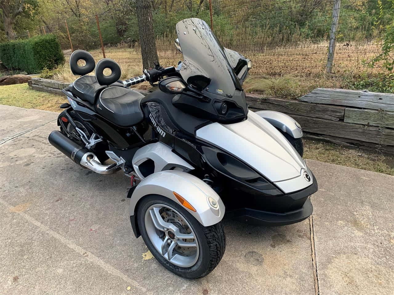 Can Am Spyder Three Wheeler Parked Outdoors Background