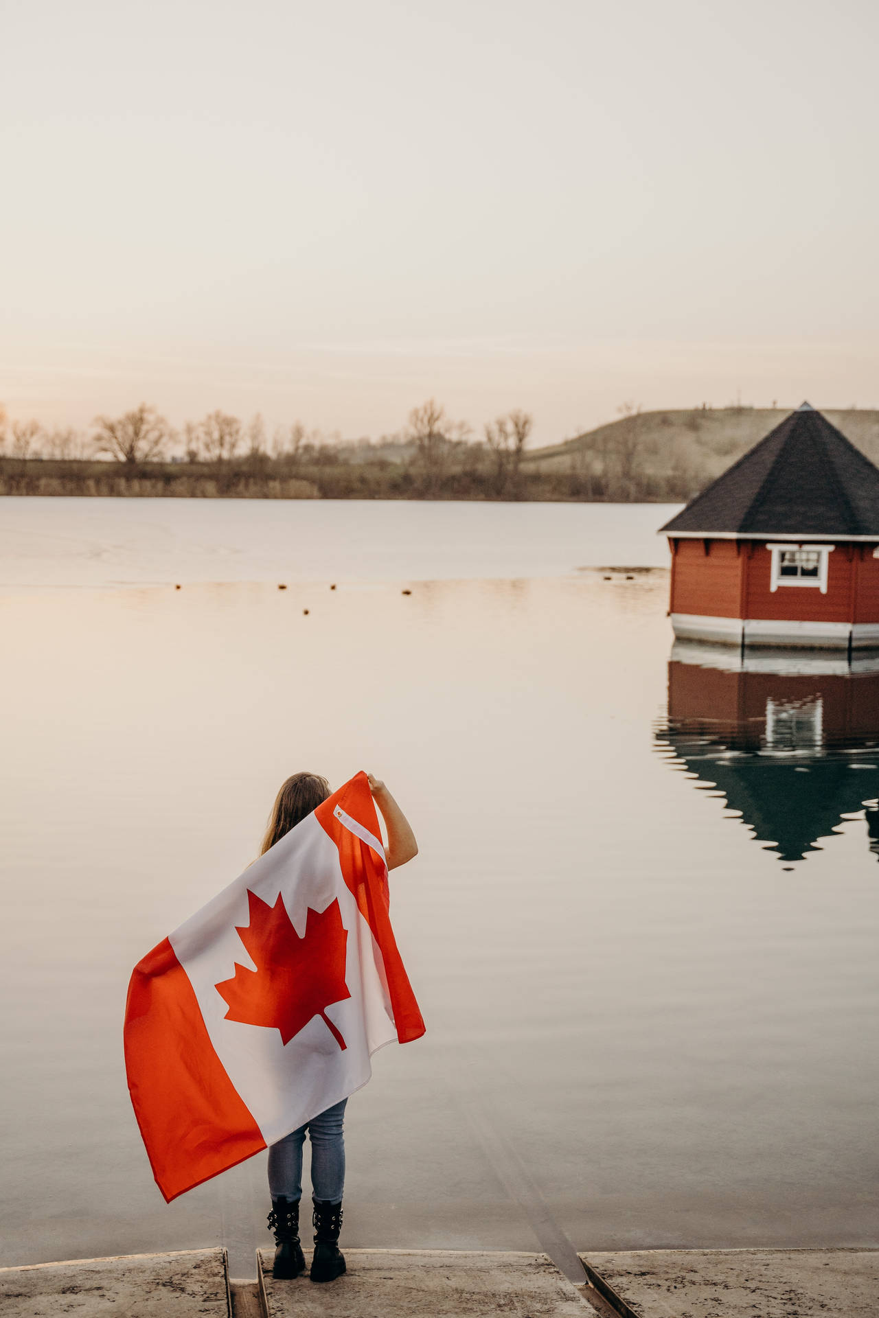 Canadian Holding Flag Lake Background