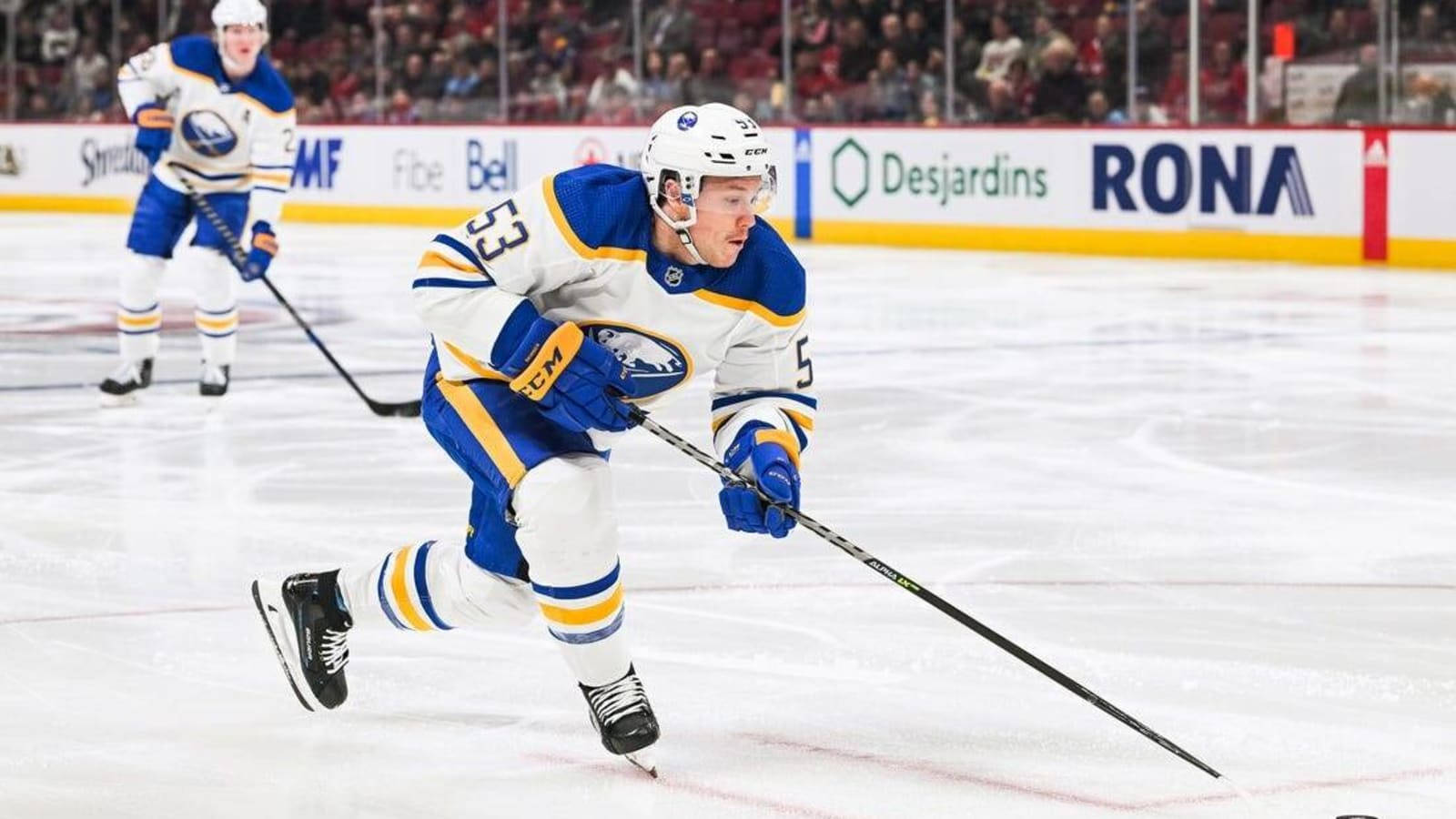 Canadian Nhl Player Jeff Skinner In Blue And Yellow Jersey Background