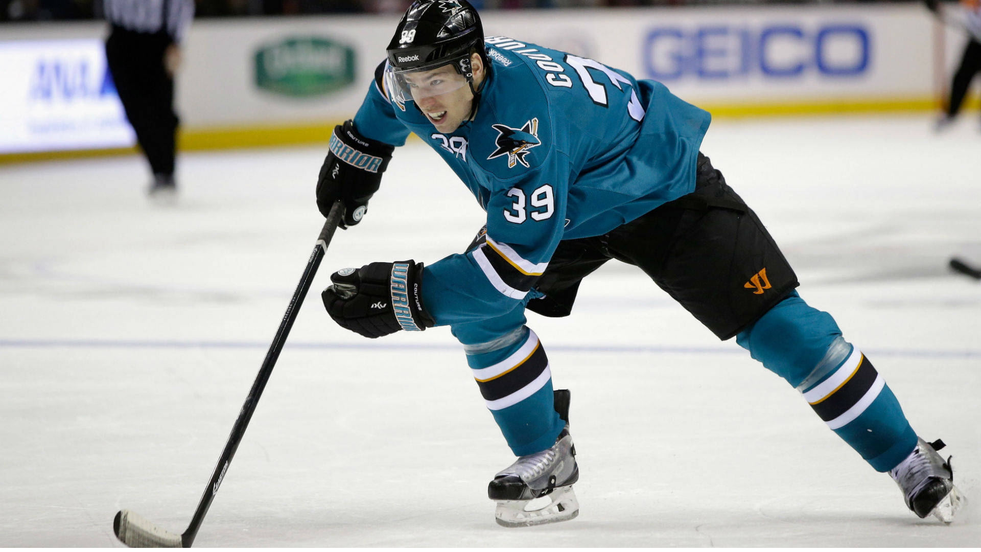 Canadian Professional Ice Hockey Center Logan Couture Playing On Rink Background