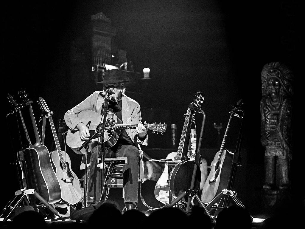 Canadian Singer Neil Young Solo Acoustic Concert Background