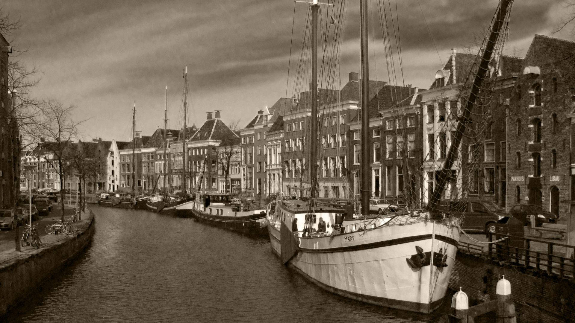 Canal With Boats And Houses Background