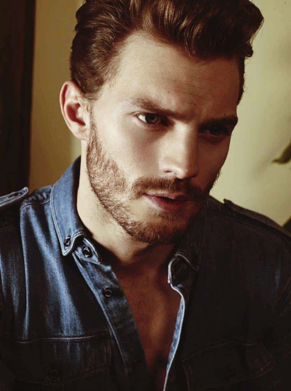 Candid Shot Of Jamie Dornan Charmingly Smirking At The Camera. Background