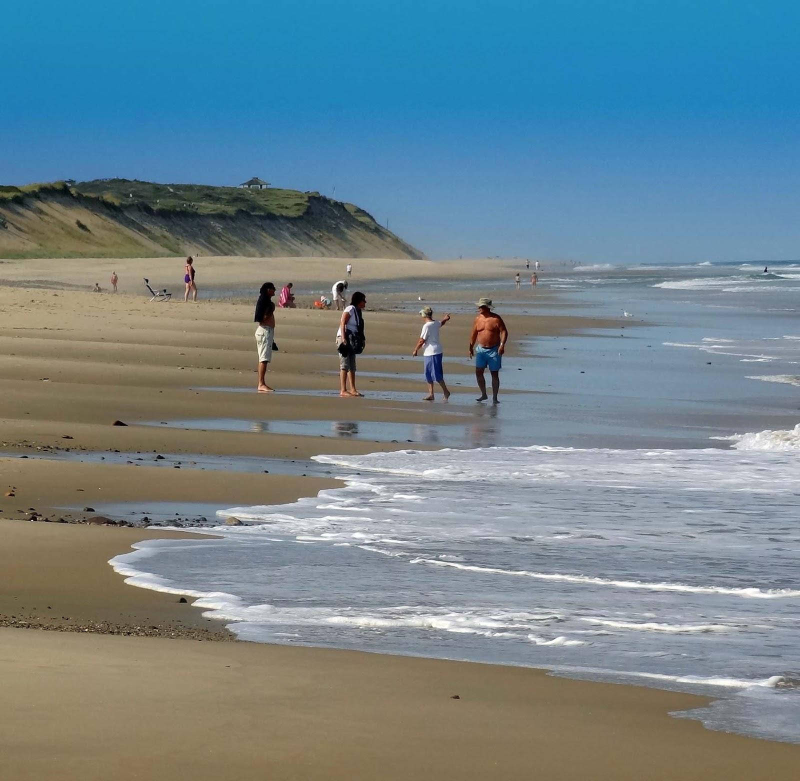 Cape Cod Tourists By The Beach Background