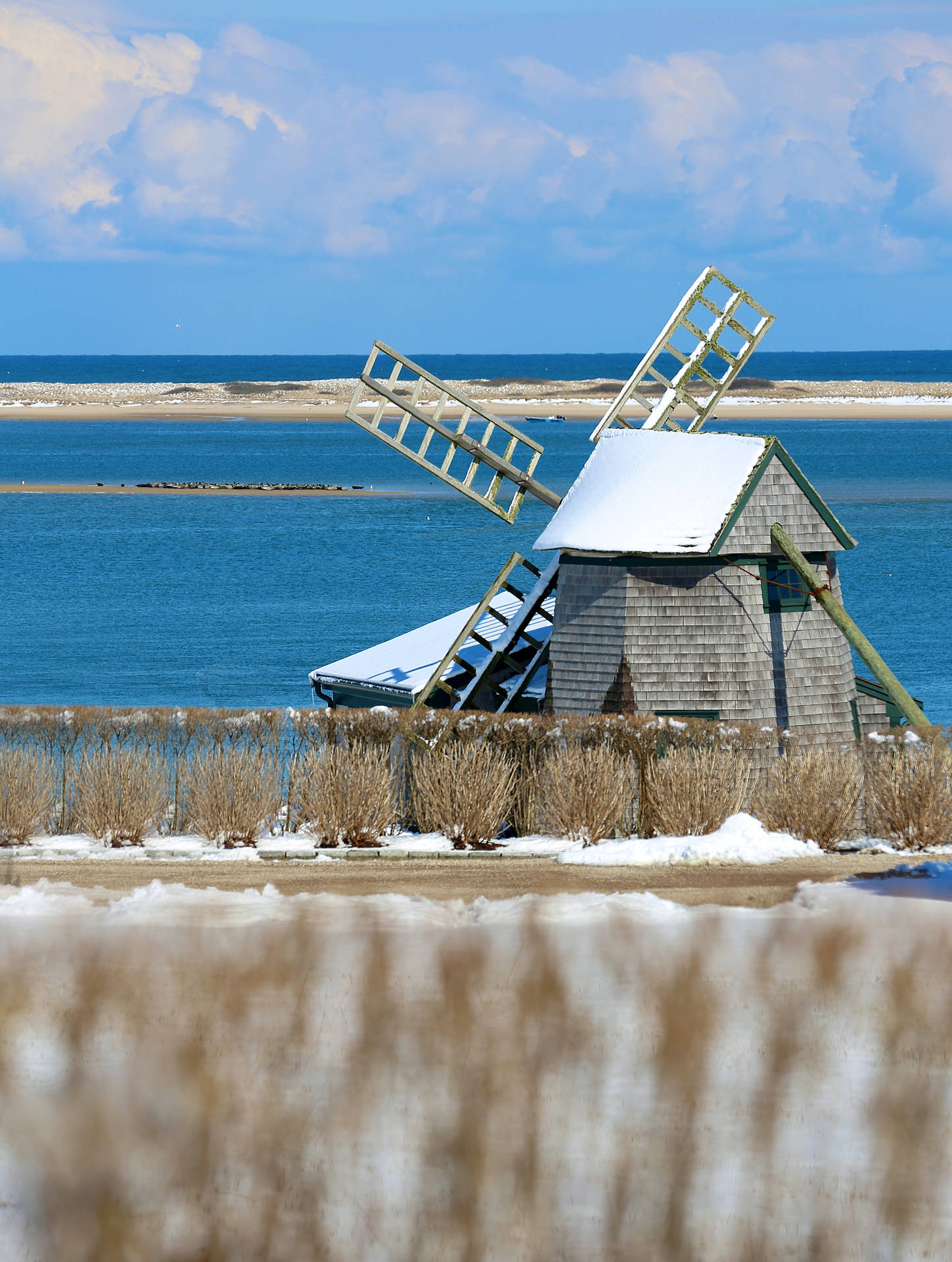 Cape Cod Windmill By The Sea Background