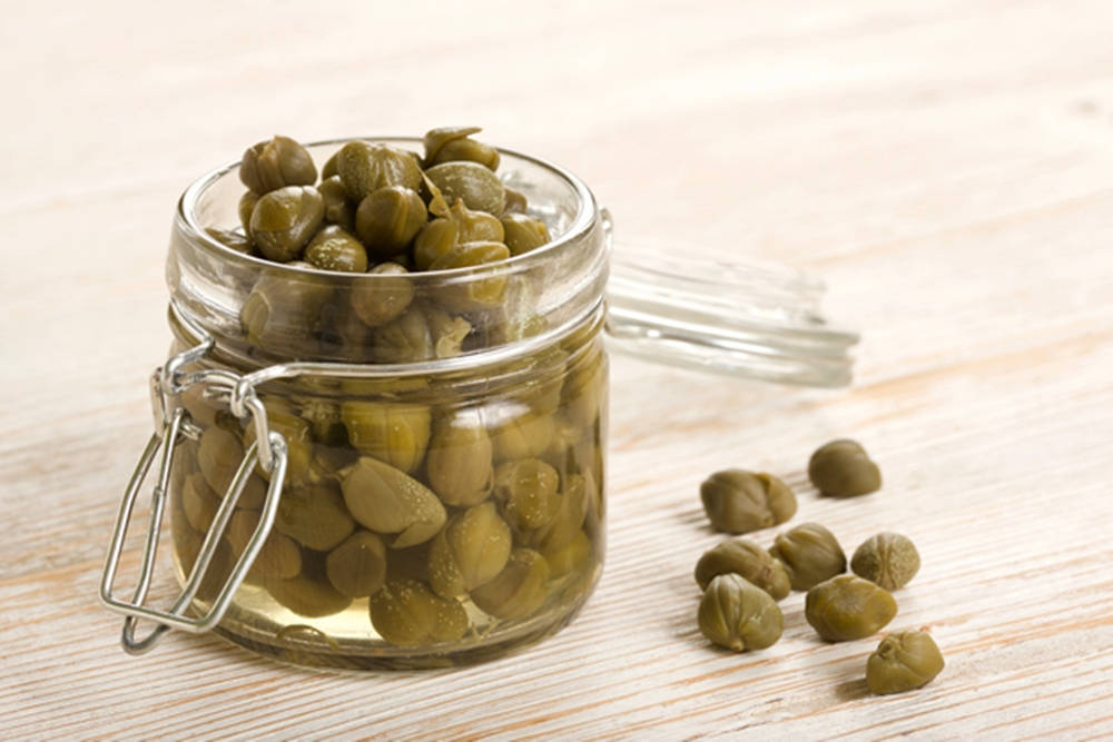 Capers In A Small Glass Jar Background