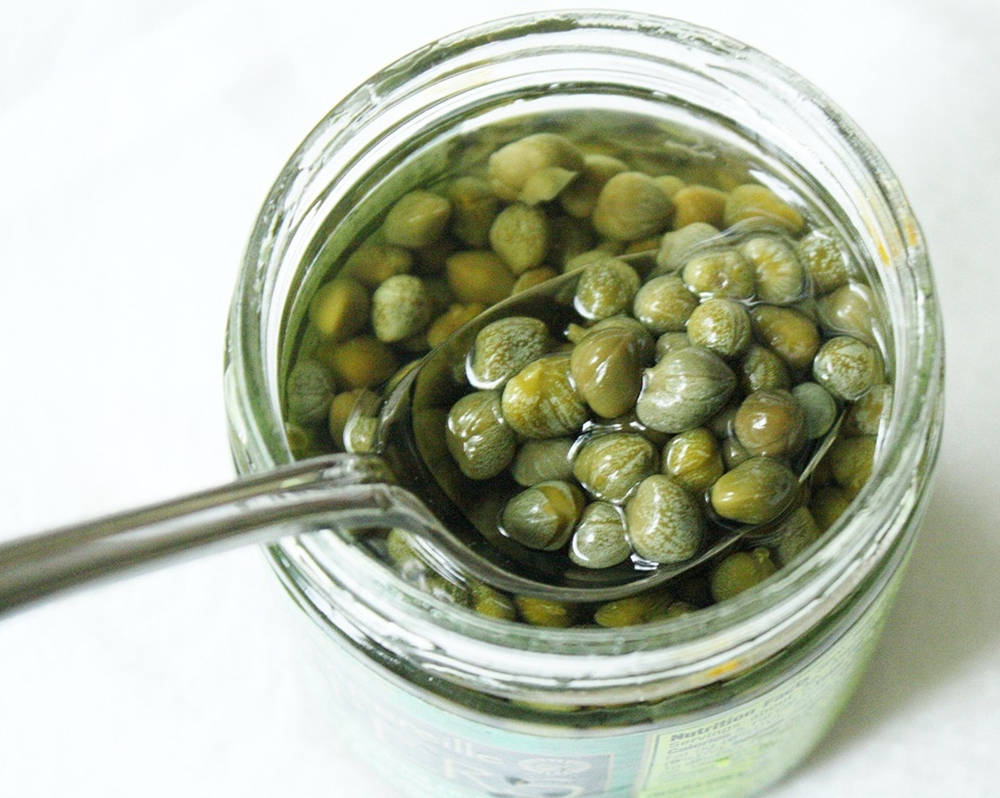 Capers Scooped From Glass Jar