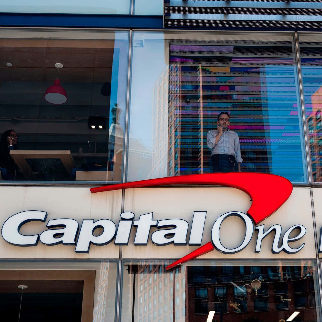 Capital One With Man Standing Background