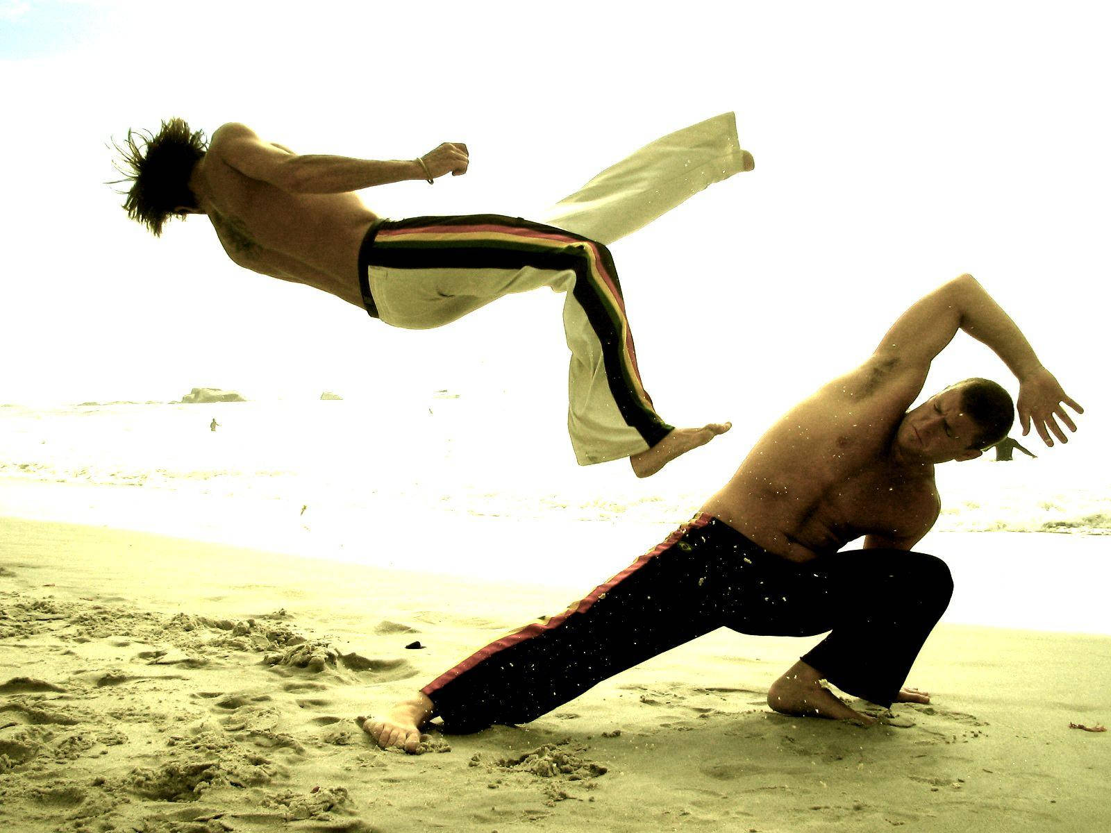 Capoeira Fighters On Sand Background