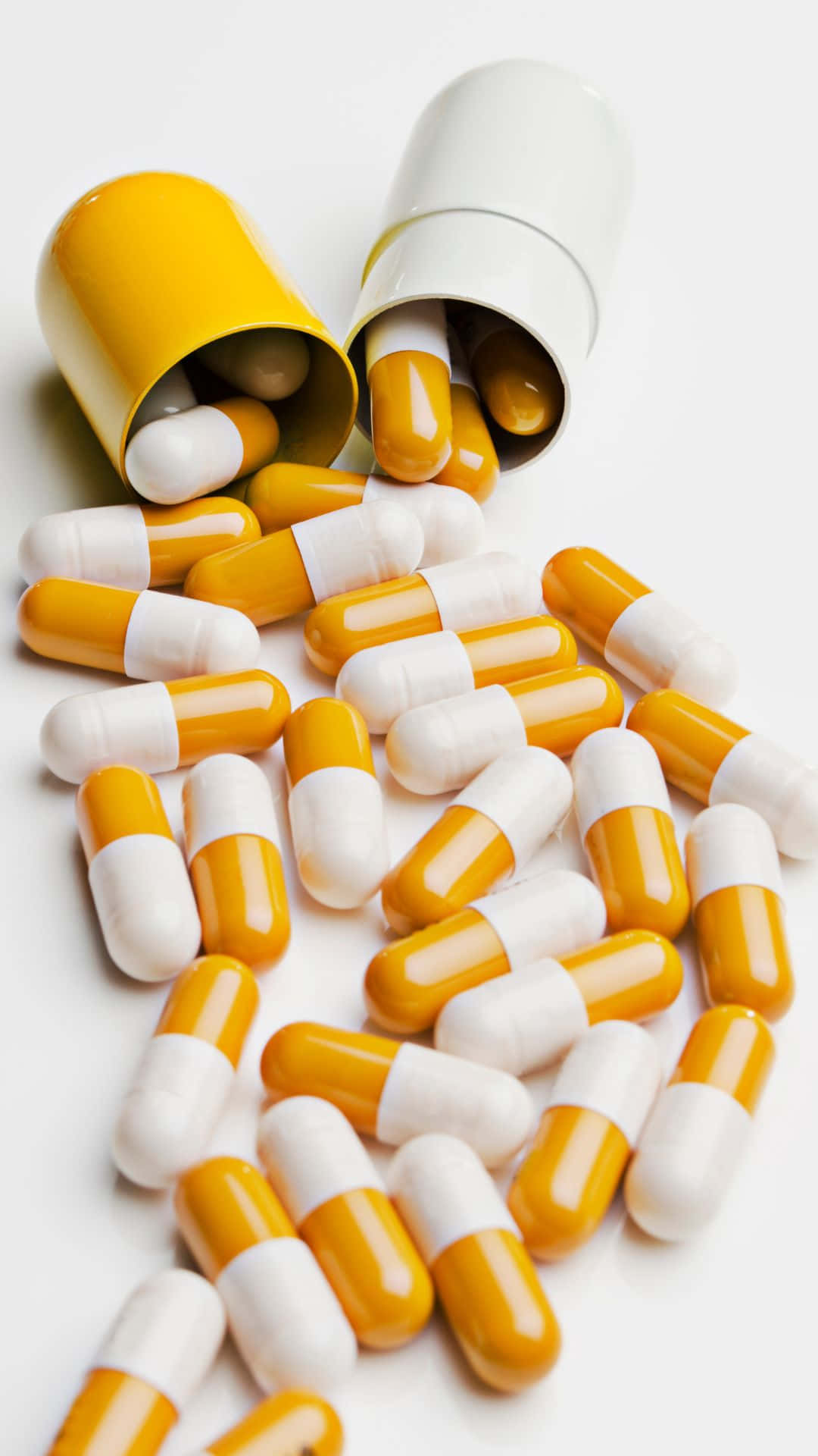 Capsules_ Spilled_ From_ Prescription_ Bottle Background