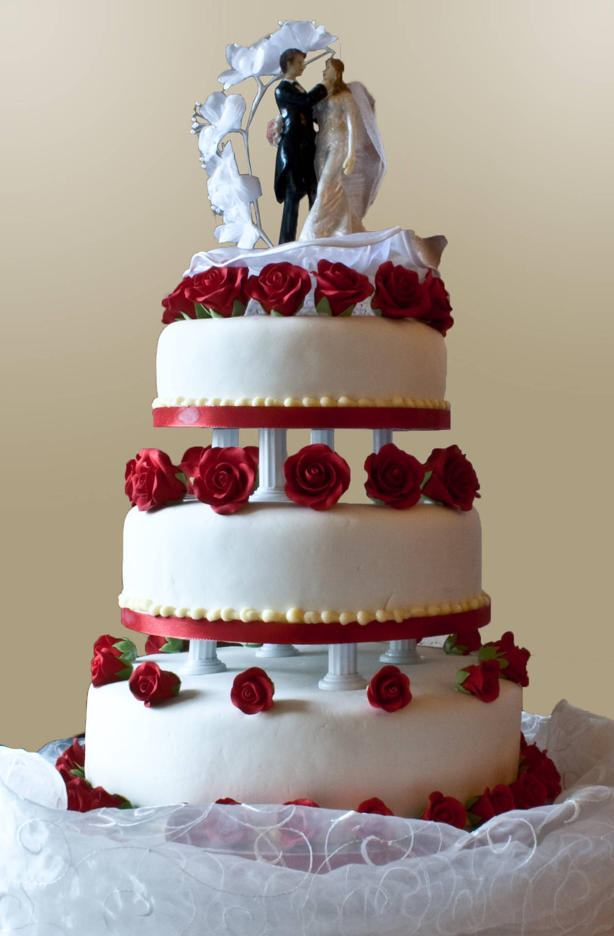 Caption: A Bride And Groom Topped Wedding Cake Background