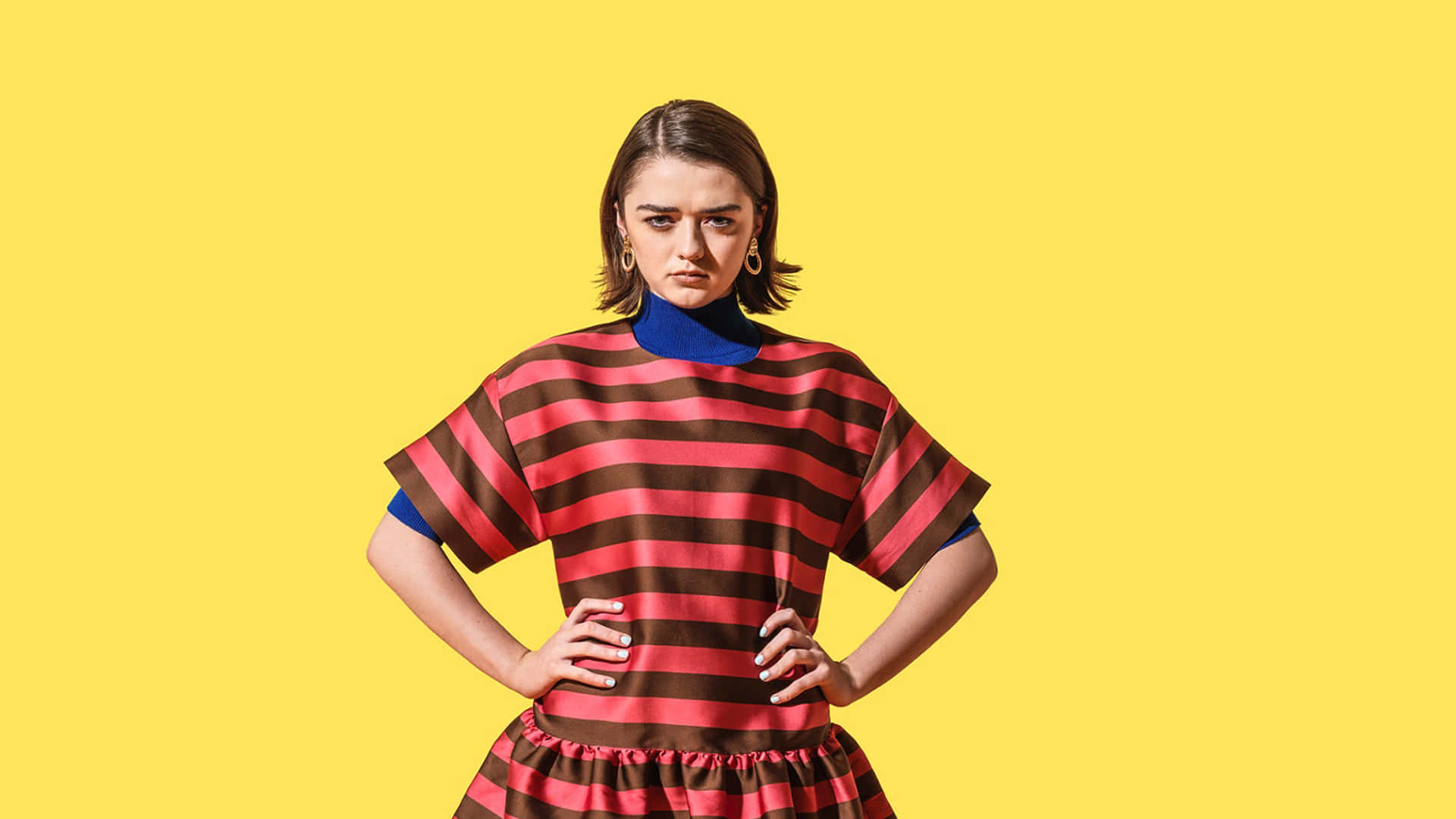 Caption: A Charismatic Maisie Williams Grasping The Attention With Her Intense Gaze. Background