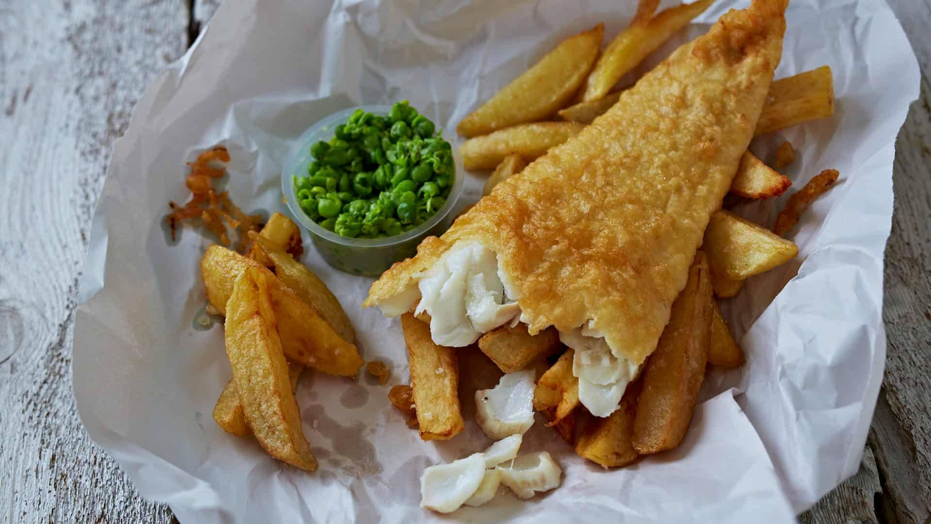 Caption: A Delightful Feast Of Half-eaten Fish And Chips