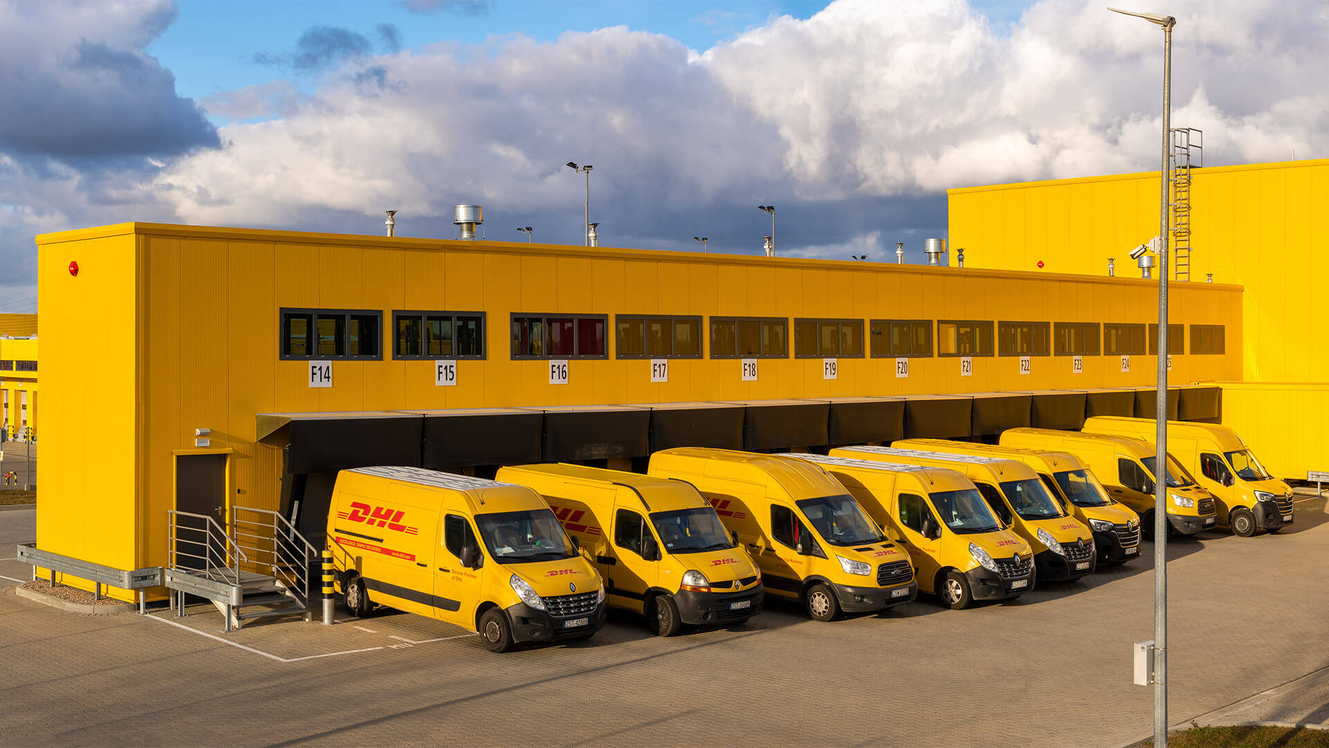 Caption: A Dhl Delivery Van In A Parking Area