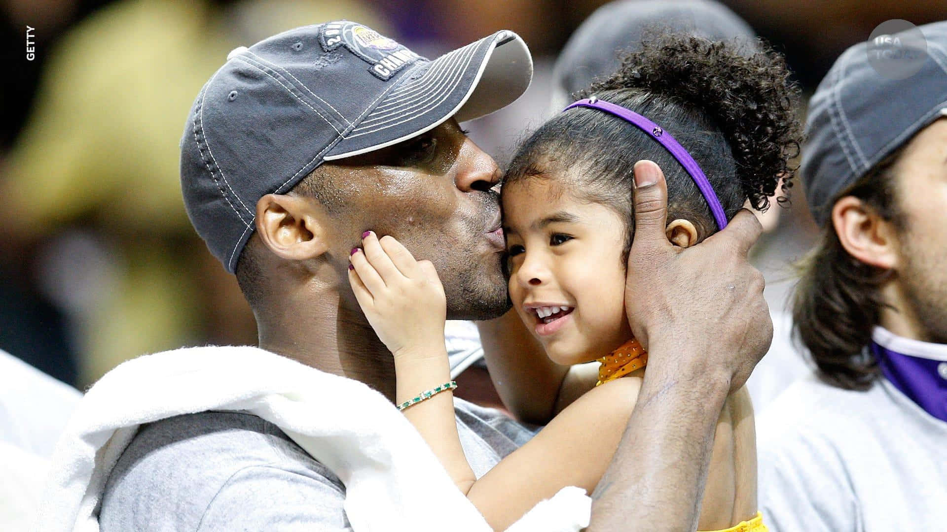 Caption: A Heartfelt Moment Between Kobe And Gigi On The Basketball Court Background