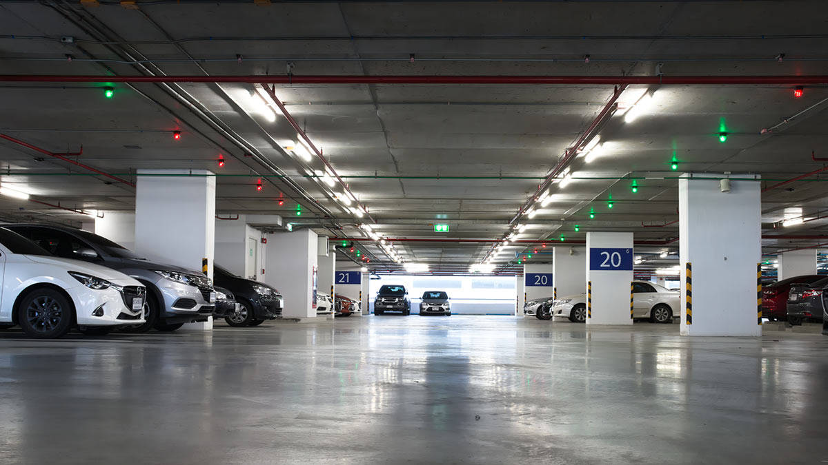 Caption: A Low-angle View In An Underground Parking Garage Background