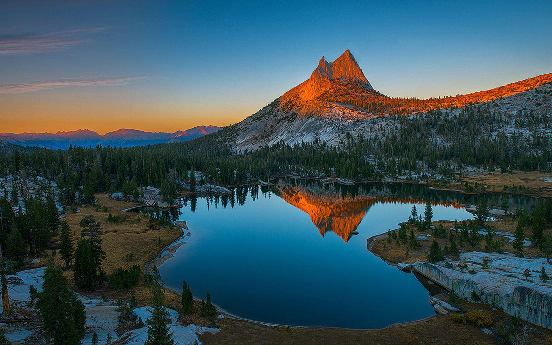 Caption: A Majestic Golden Sunset Over Rocky Mountain National Park