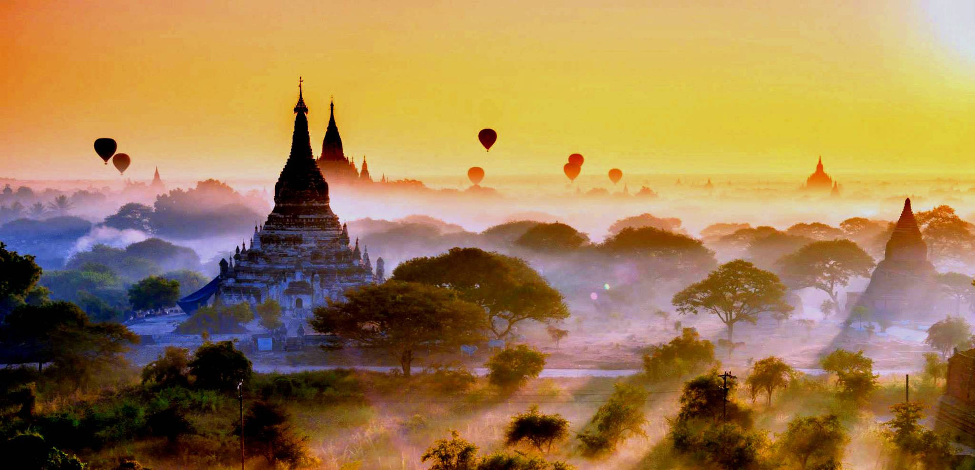 Caption: A Majestic View Of Yangon Ancient City At Dusk Background