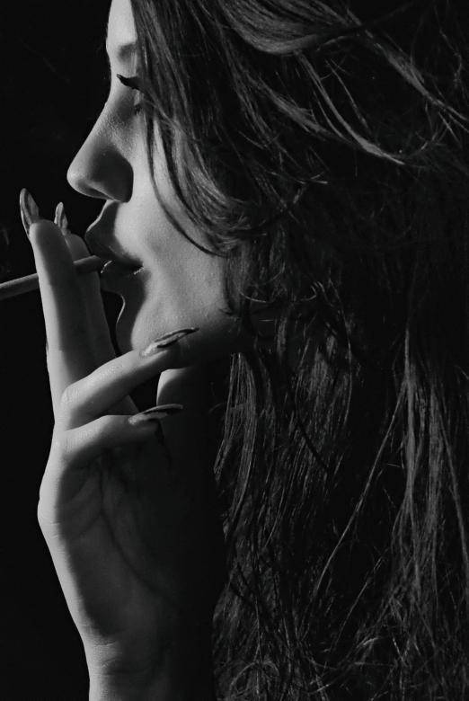 Caption: A Man Contemplating While Smoking A Cigarette. Background