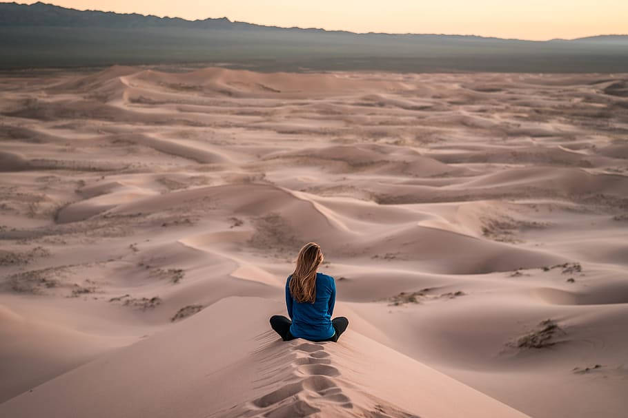 Caption: A Mongolian Girl Embracing The Beauty Of Her Native Desert Background