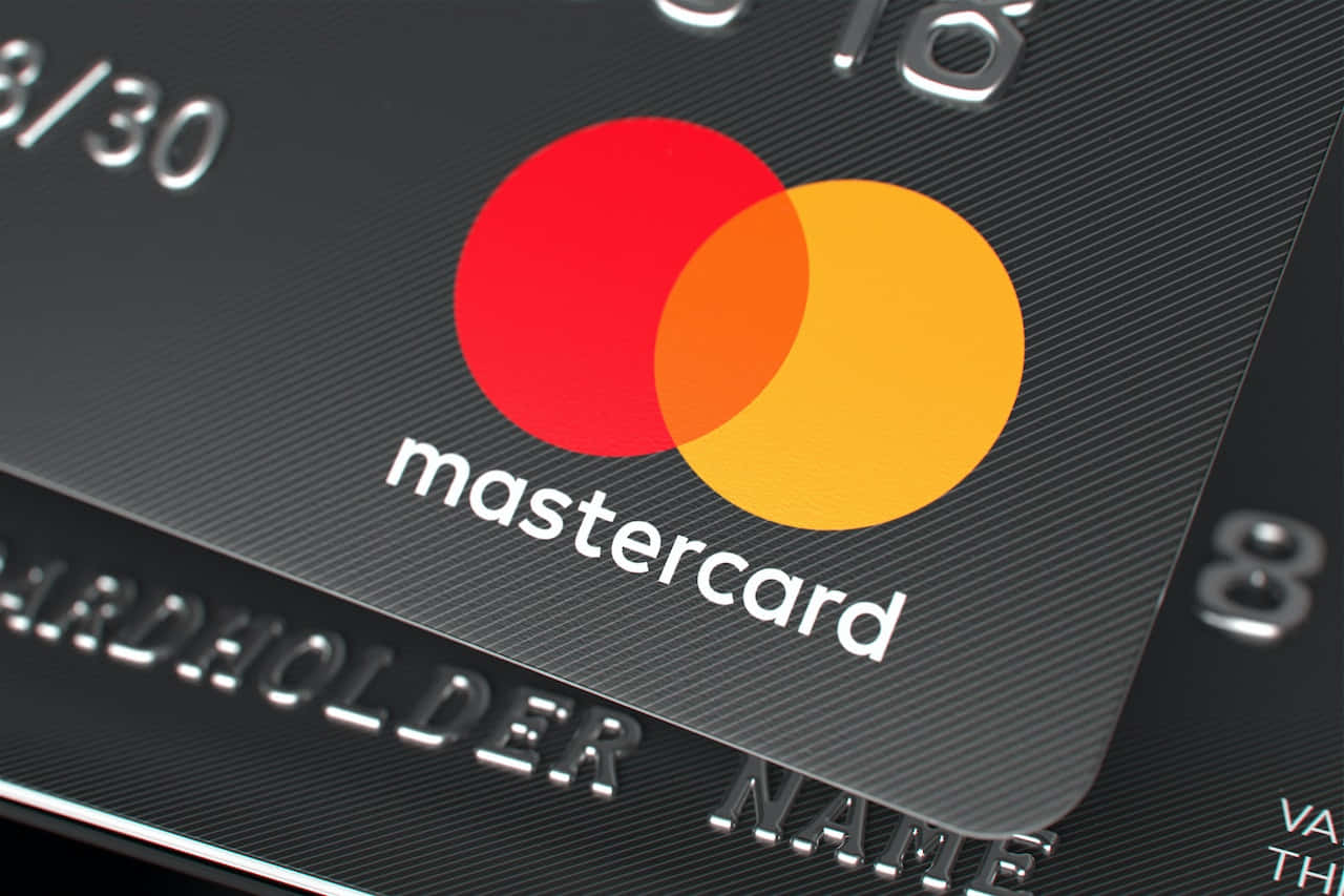 Caption: A Person Shopping Online With Their Mastercard Background