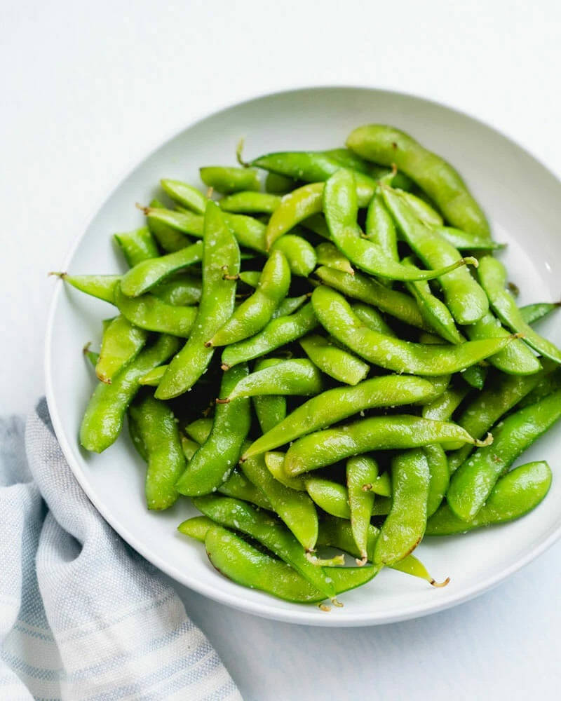 Caption: A Tantalizing Bowl Of Stir-fried Edamame Beans Background