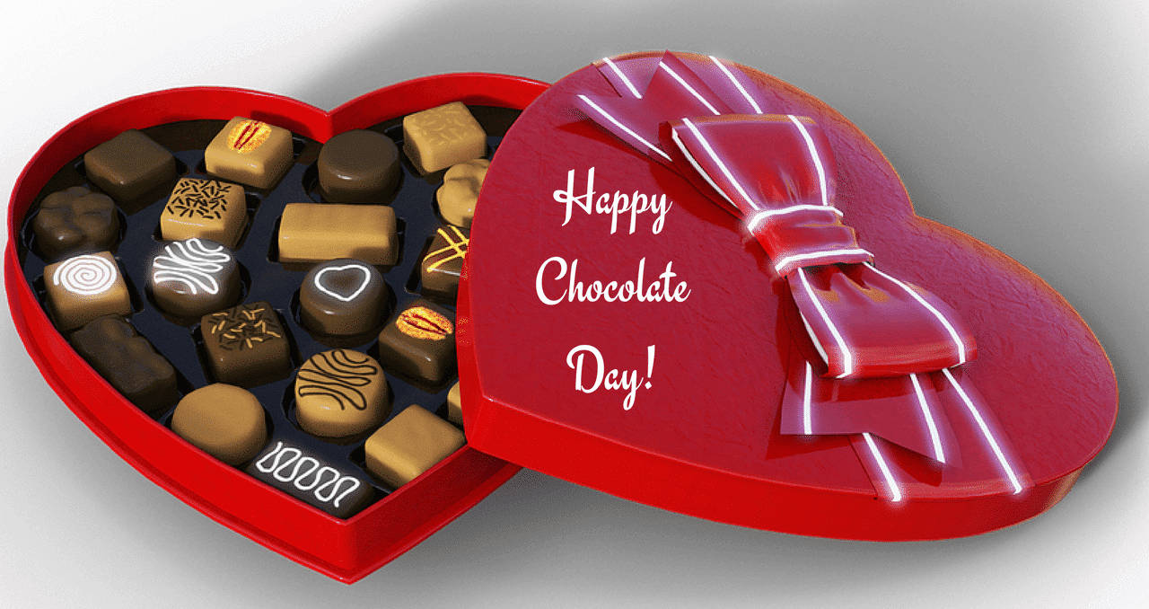 Caption: A Tempting Collection Of Assorted Chocolates On Chocolate Day Background