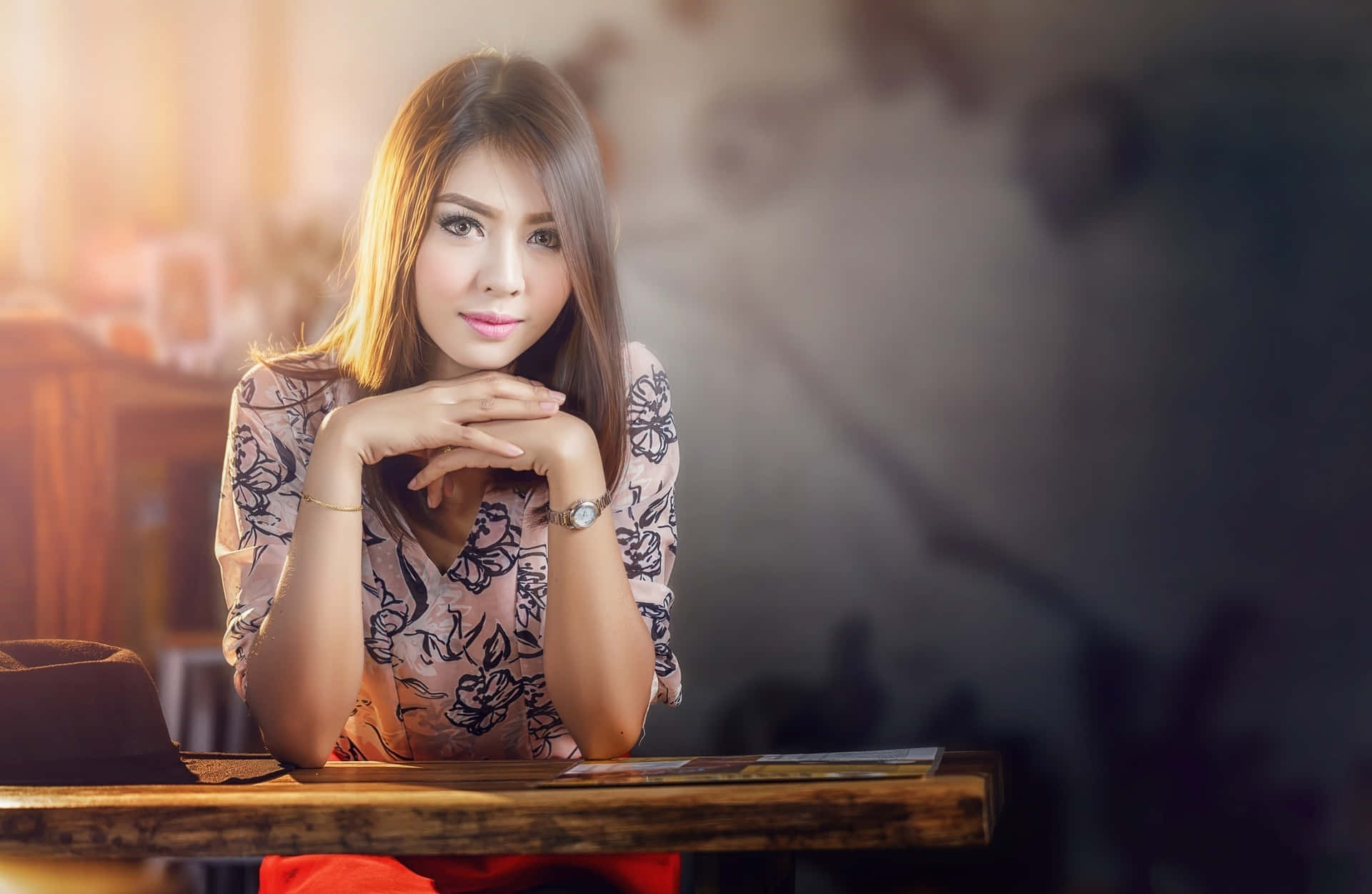 Caption: A Thai Girl Leaning On A Wooden Desk In Traditional Attire Background