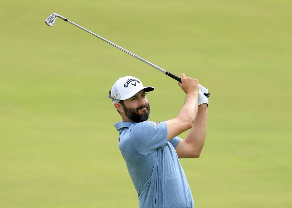 Caption: Adam Hadwin Powerfully Swinging For A Golf Shot