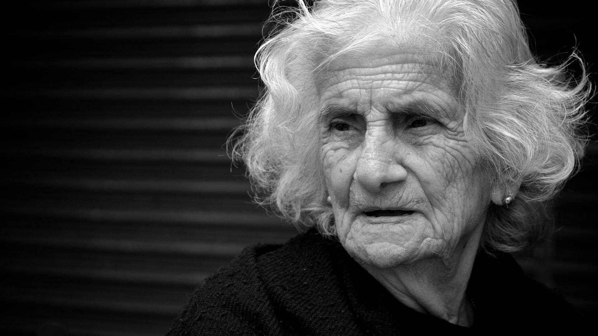 Caption: Ageless Beauty: Portrait Of A Stunning Older Woman Background