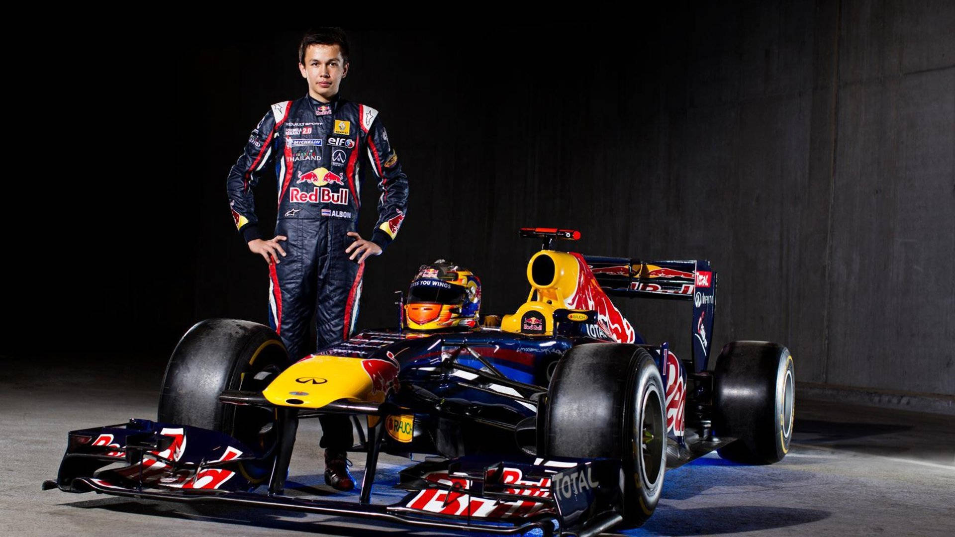 Caption: Alexander Albon In Red Bull Racing Gear Background