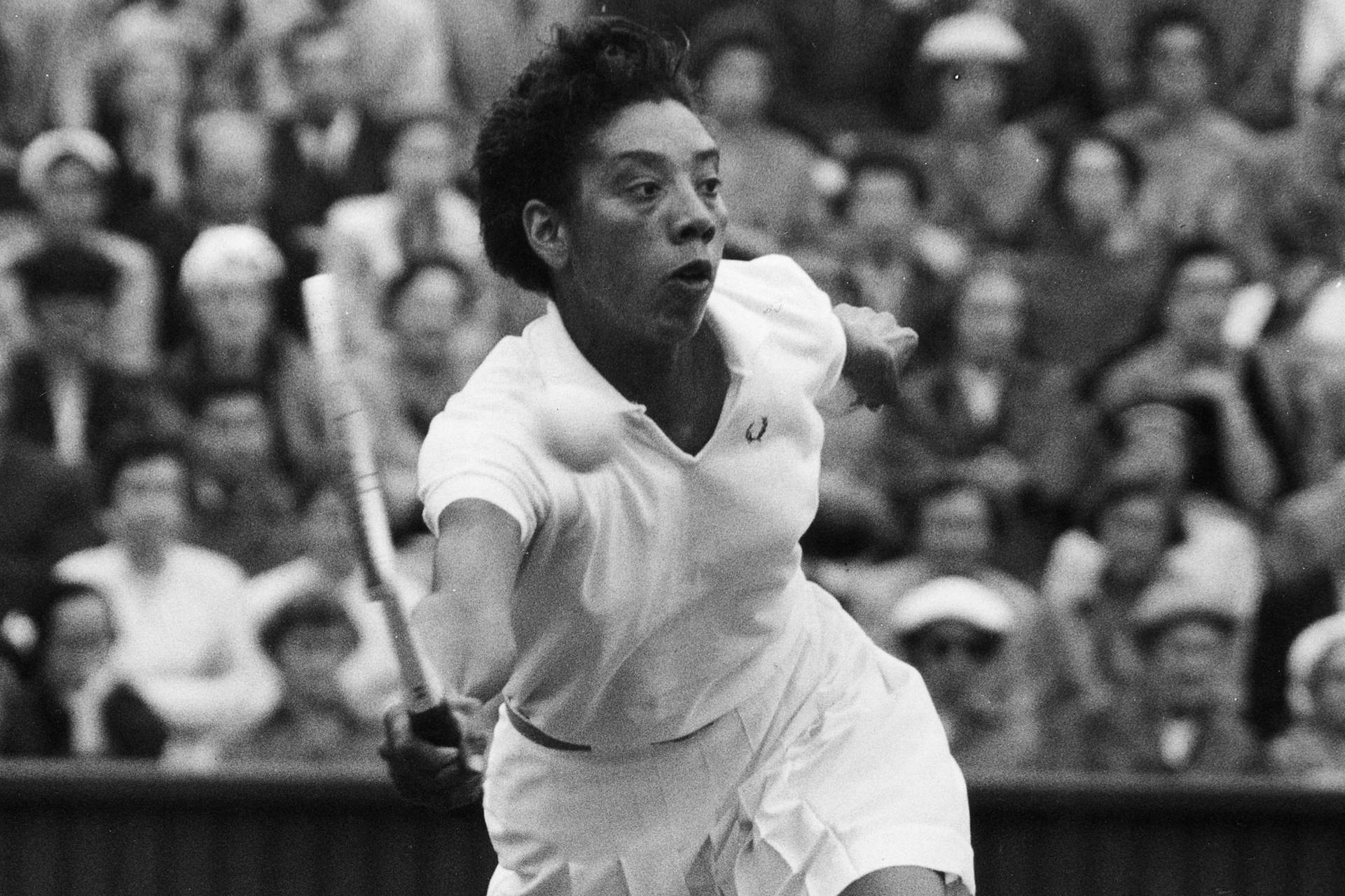 Caption: Althea Gibson Smashing A Tennis Match Background