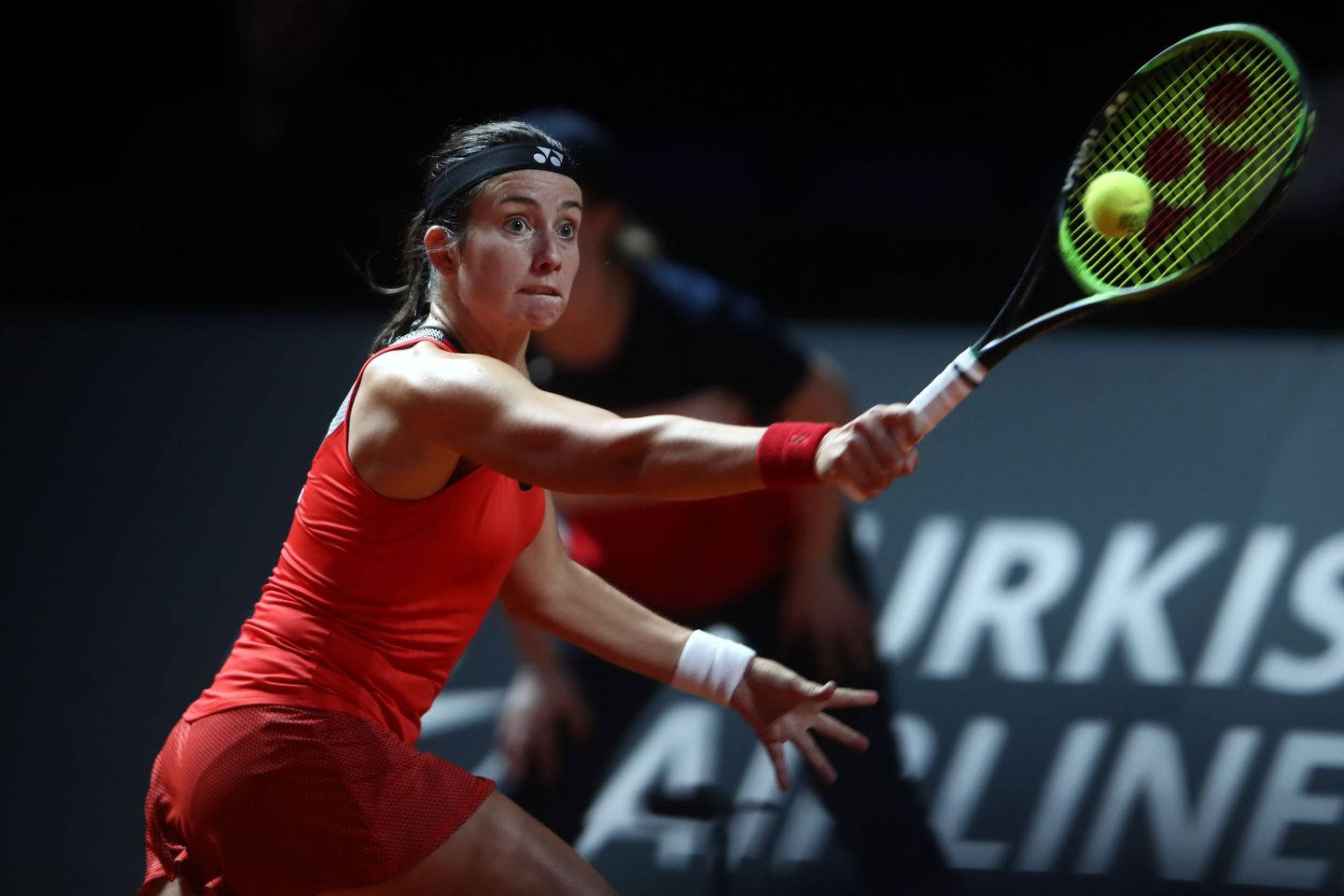 Caption: Anastasija Sevastova Dominating The Game In A Striking Red Outfit. Background