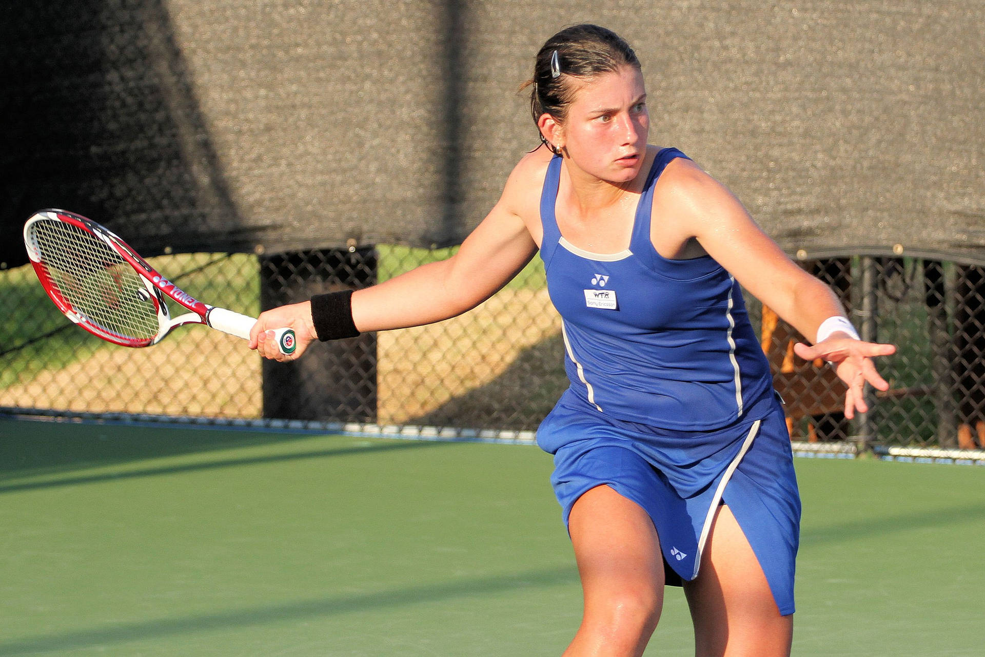 Caption: Anastasija Sevastova's In-action Capture While Waiting For The Ball In A Tennis Match Background