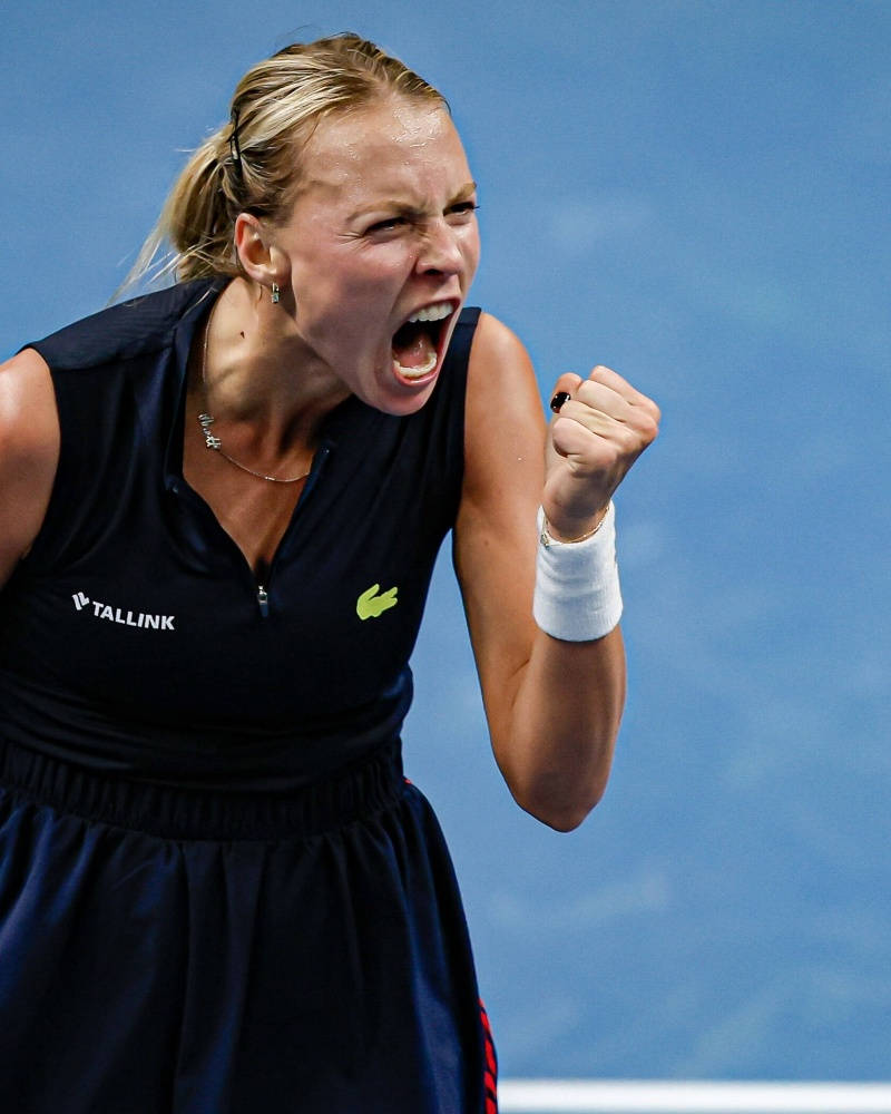 Caption: Anett Kontaveit Celebrating Victory With A Fist Pump Background