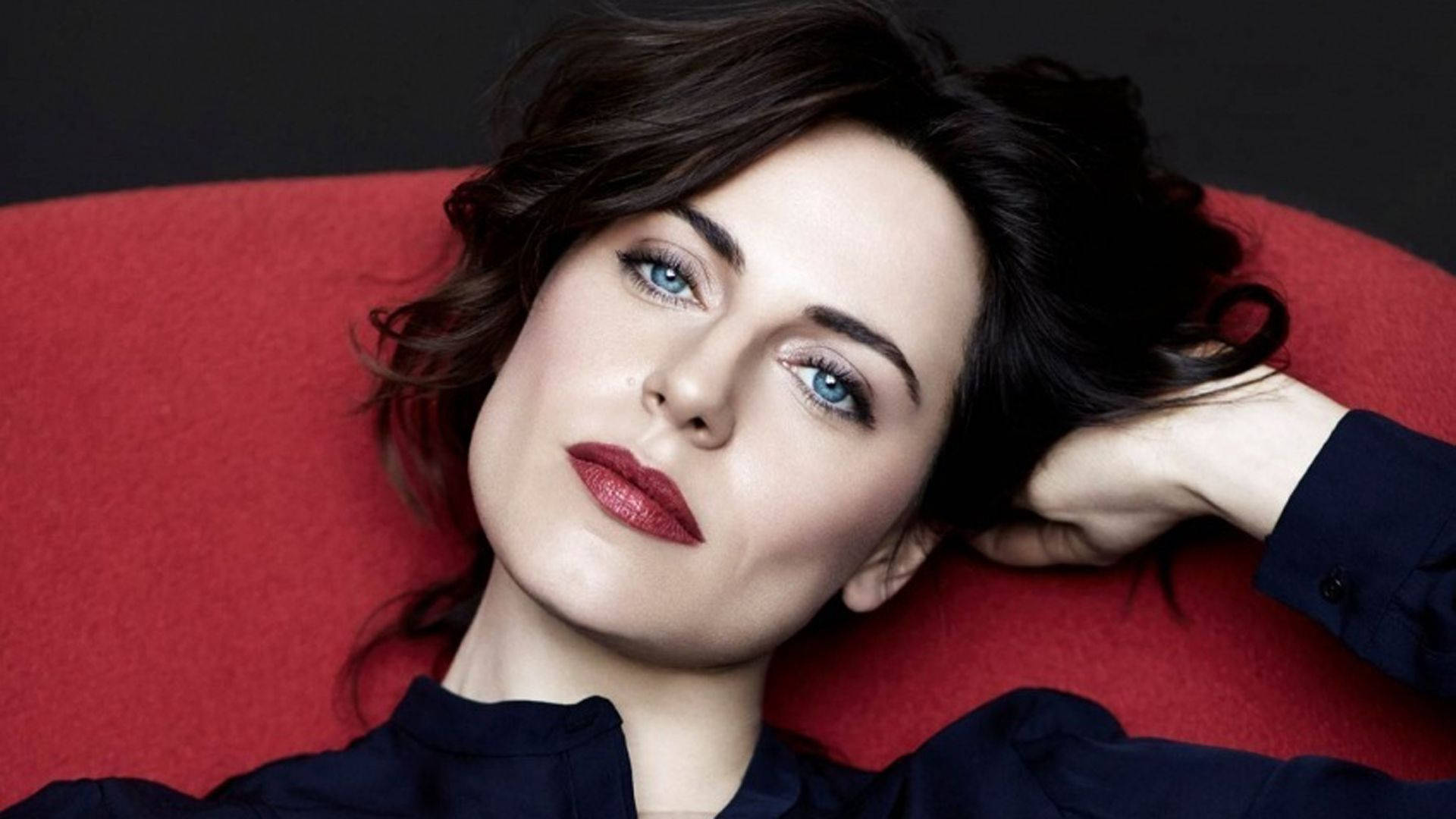 Caption: Antje Traue In Chic Red Chair Background