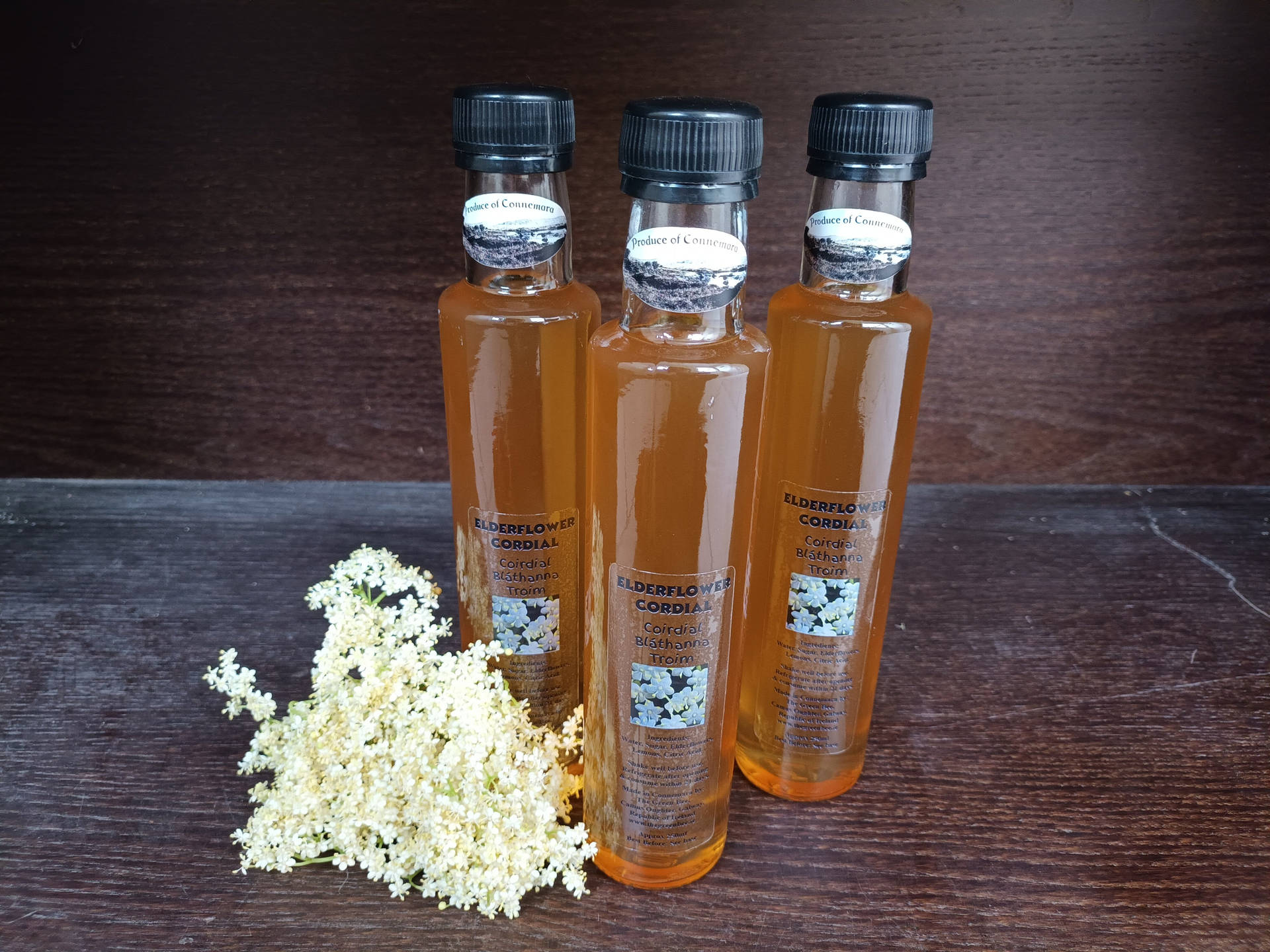 Caption: Artisan Elderflower Cordial Bottles Background