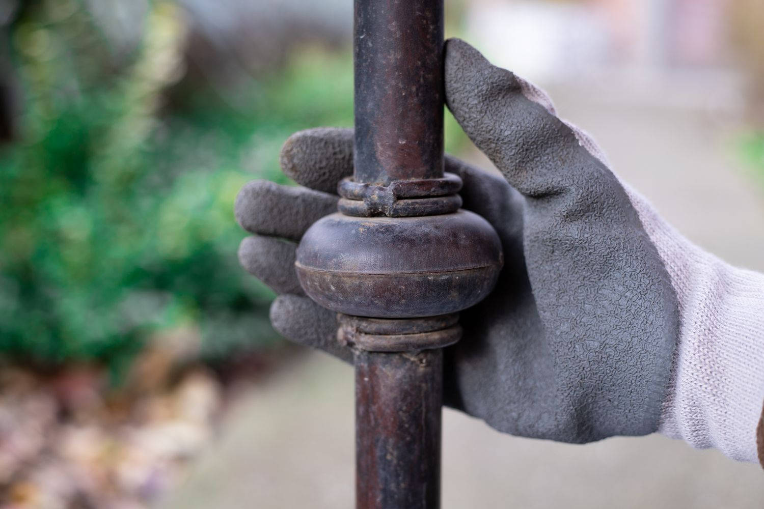 Caption: Artist's Hand Touching A Rustic Iron Surface Background