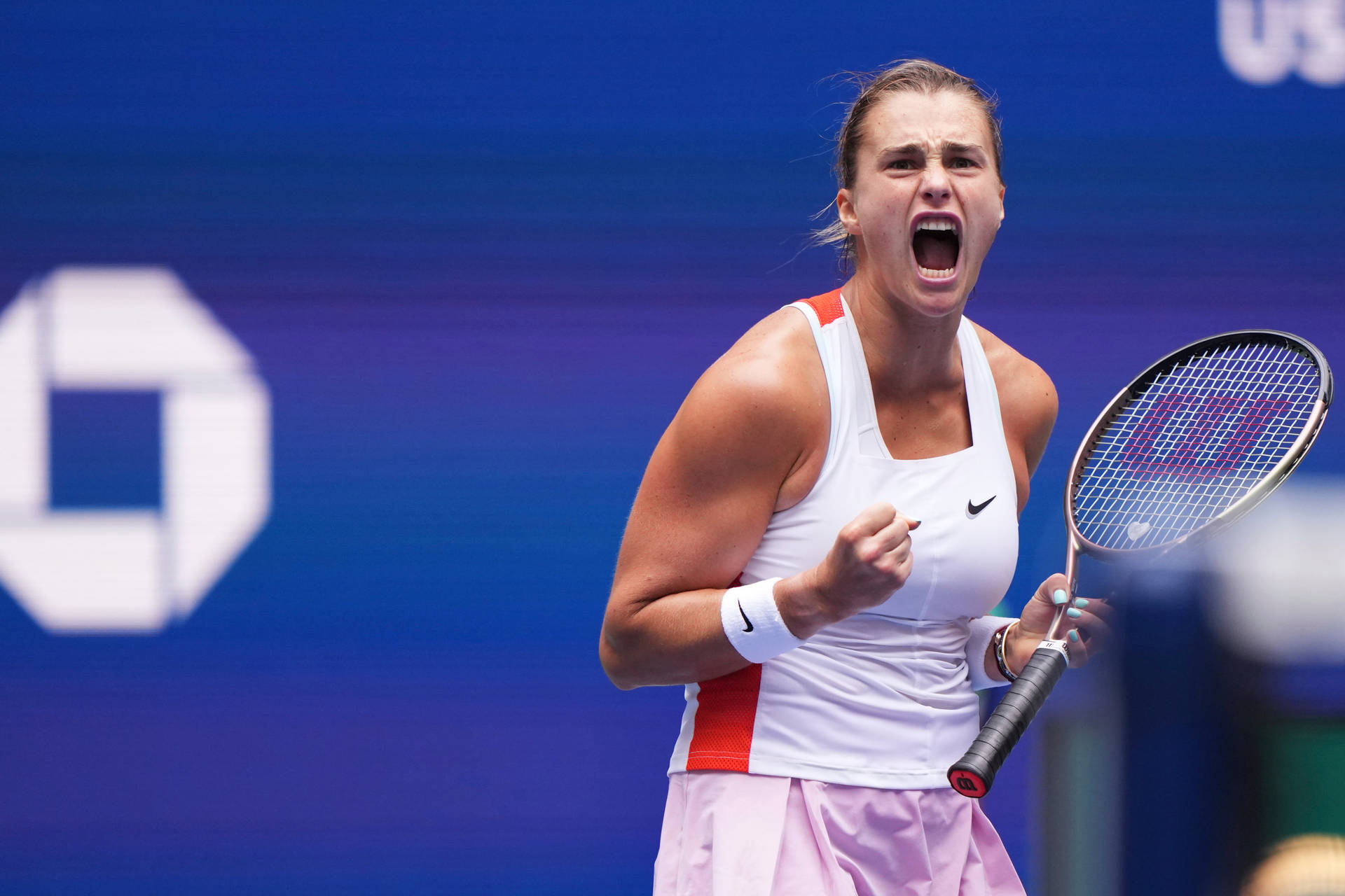 Caption: Aryna Sabalenka Expressing Intensity On The Tennis Court. Background