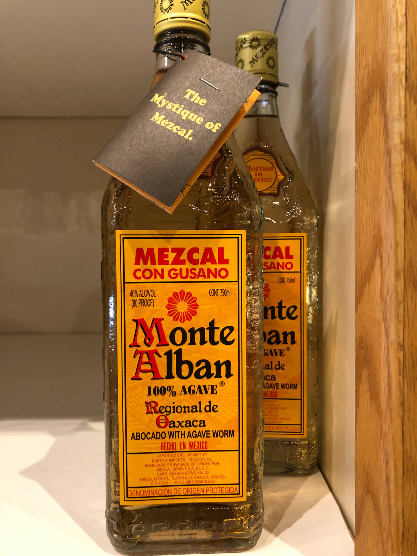 Caption: Authentic Monte Alban Mezcal Tequila Bottles Background