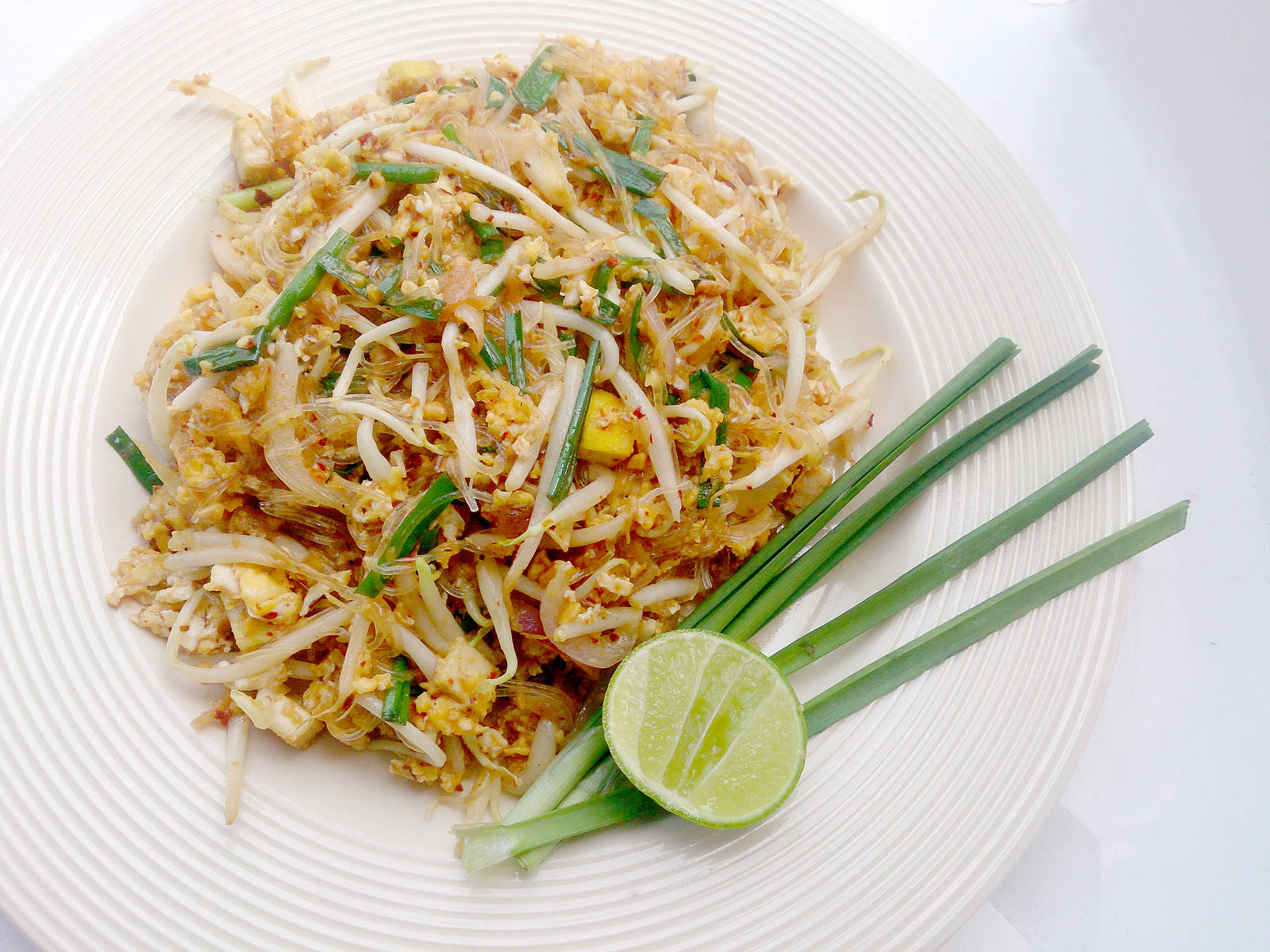 Caption: Authentic Pad Thai Garnished With Spring Onions Background